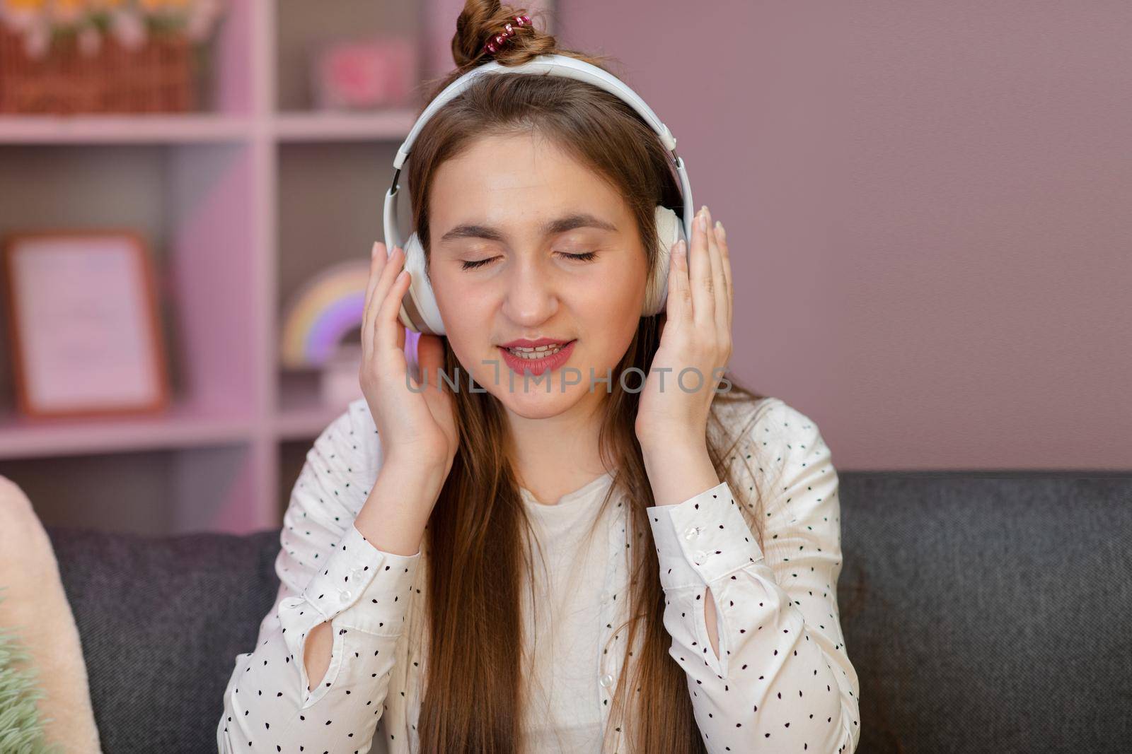 Beautiful woman listening to music at home. by uflypro