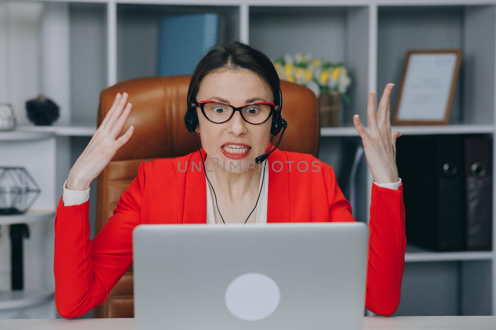 Angry girl at workplace. Upset business woman. Depressed businesswoman blogger vlogger influencer sit at home speaking looking at camera talking make video chat.