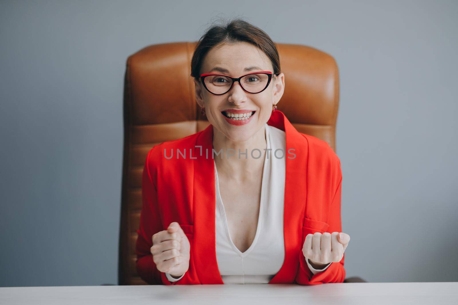 Cute girl holding her glasses and smiling. Beautiful happy businesswoman working at home office by uflypro