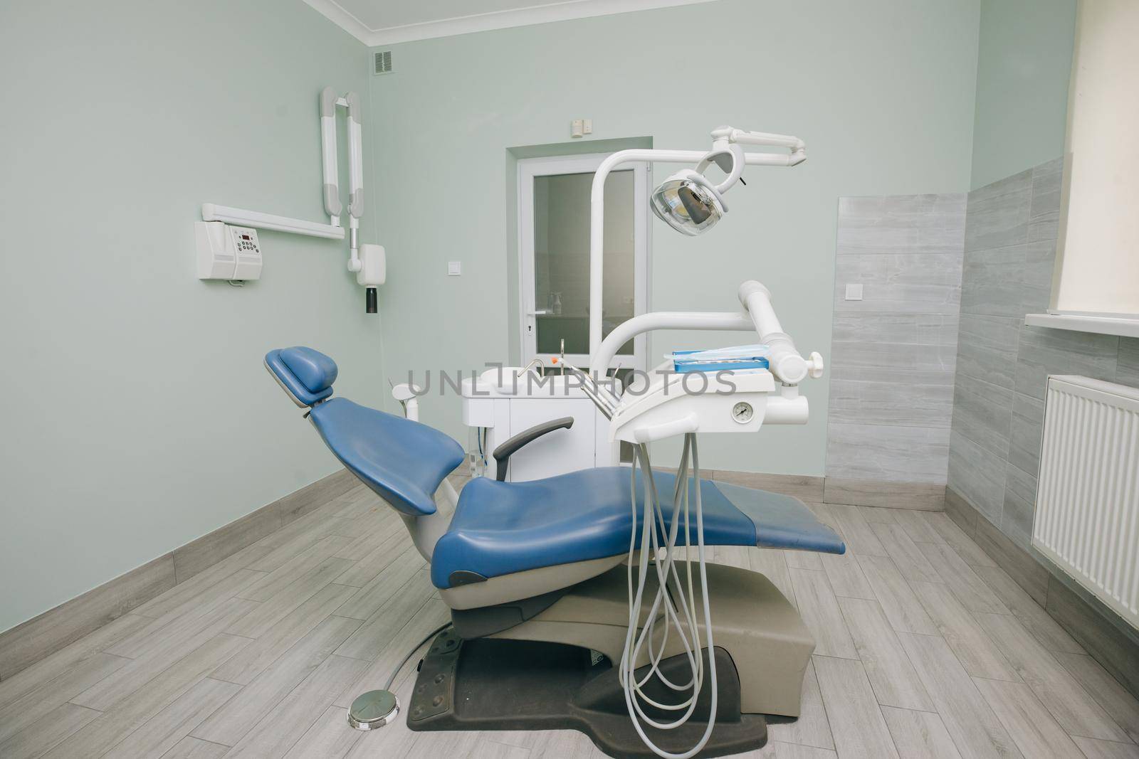 Modern dental practice. Dental chair and other accessories used by dentists in blue, medic light. Dentist Office, Dental Hygiene, Dentist's Chair by uflypro