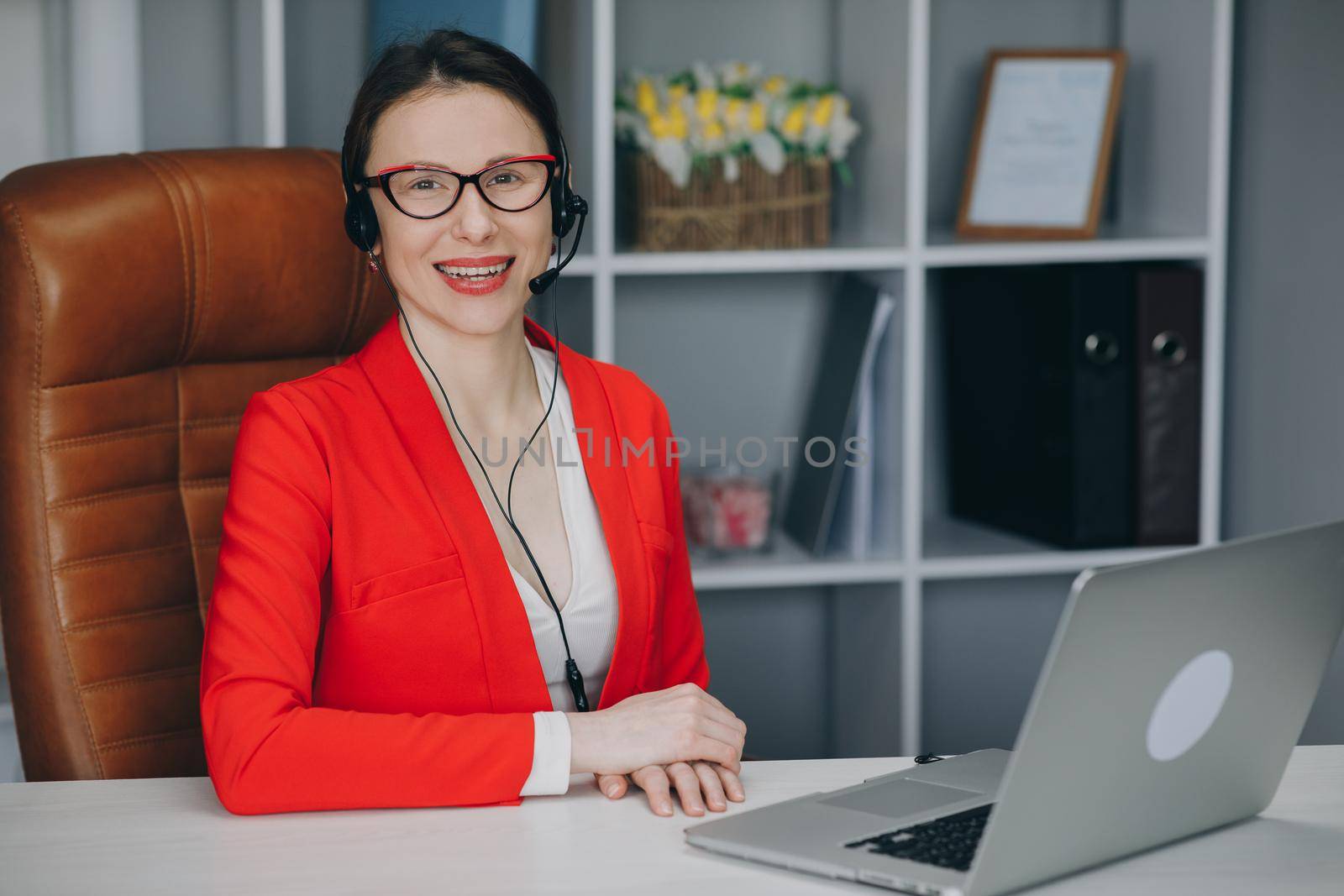 Woman wear headset communicating by conference call speak looking at camera at home office. Video chat job interview or distance language course class with online teacher concept by uflypro