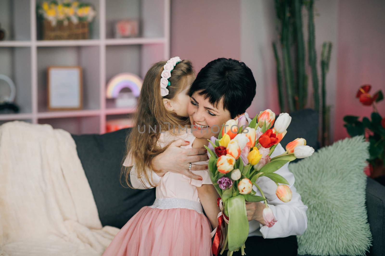 Happy Mother's Day Joy. Kissing and hugging happy family. Beautiful Mother And her little daughter. Smiling Caucasian Senior Mother with her Adult Daughter Hugging and Kisses in Mother's Day. by uflypro