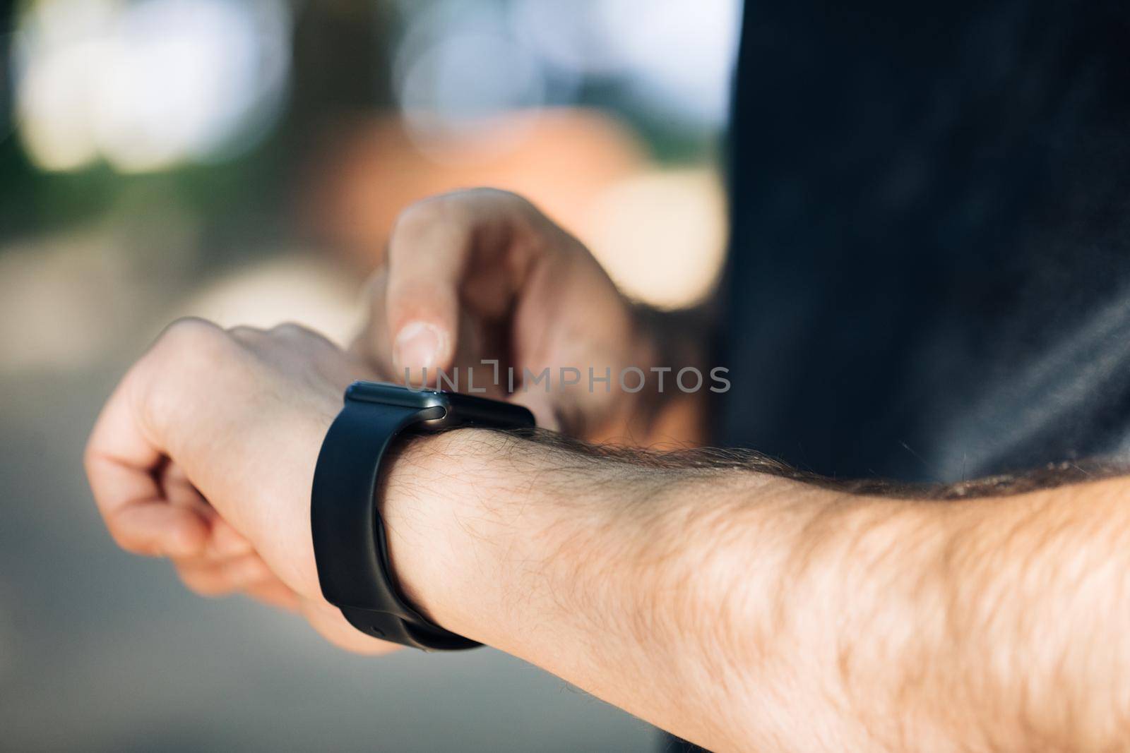 Young man trying new smart watch. Smart watch. Man Using Smart Watch. Closeup