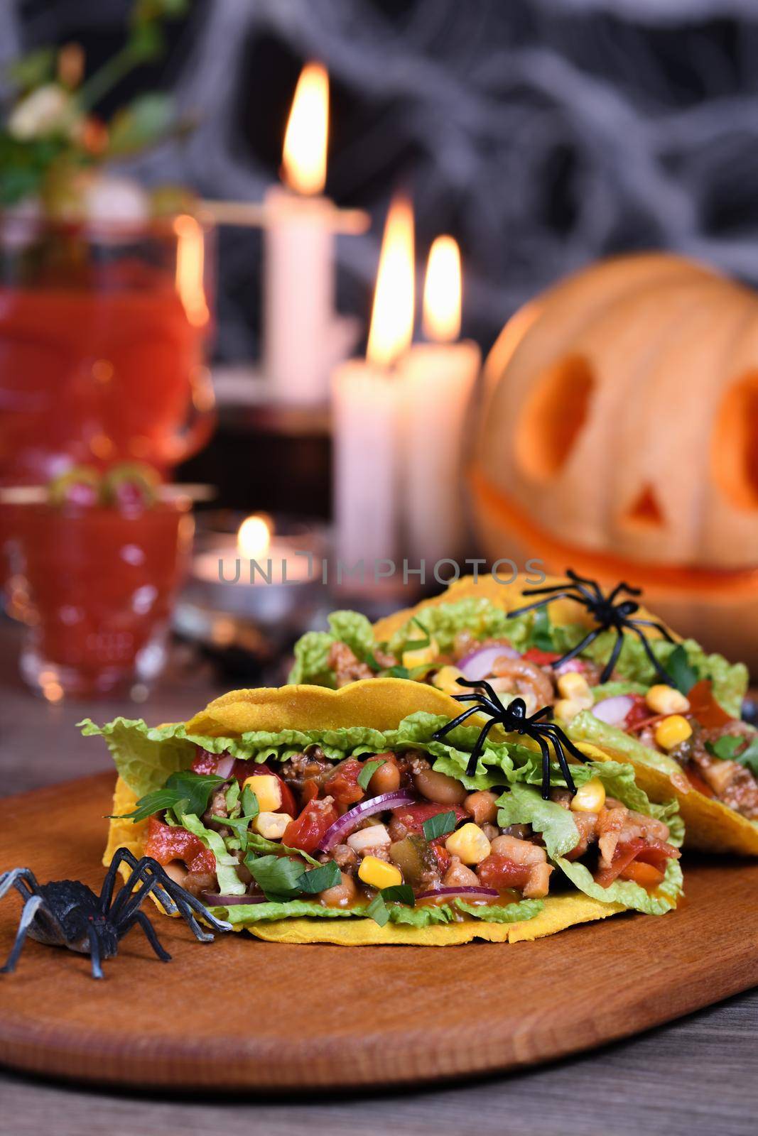 Halloween Food. Mexican corn tortilla tacos with vegetables and chicken. Add some burning gustatory color to your party