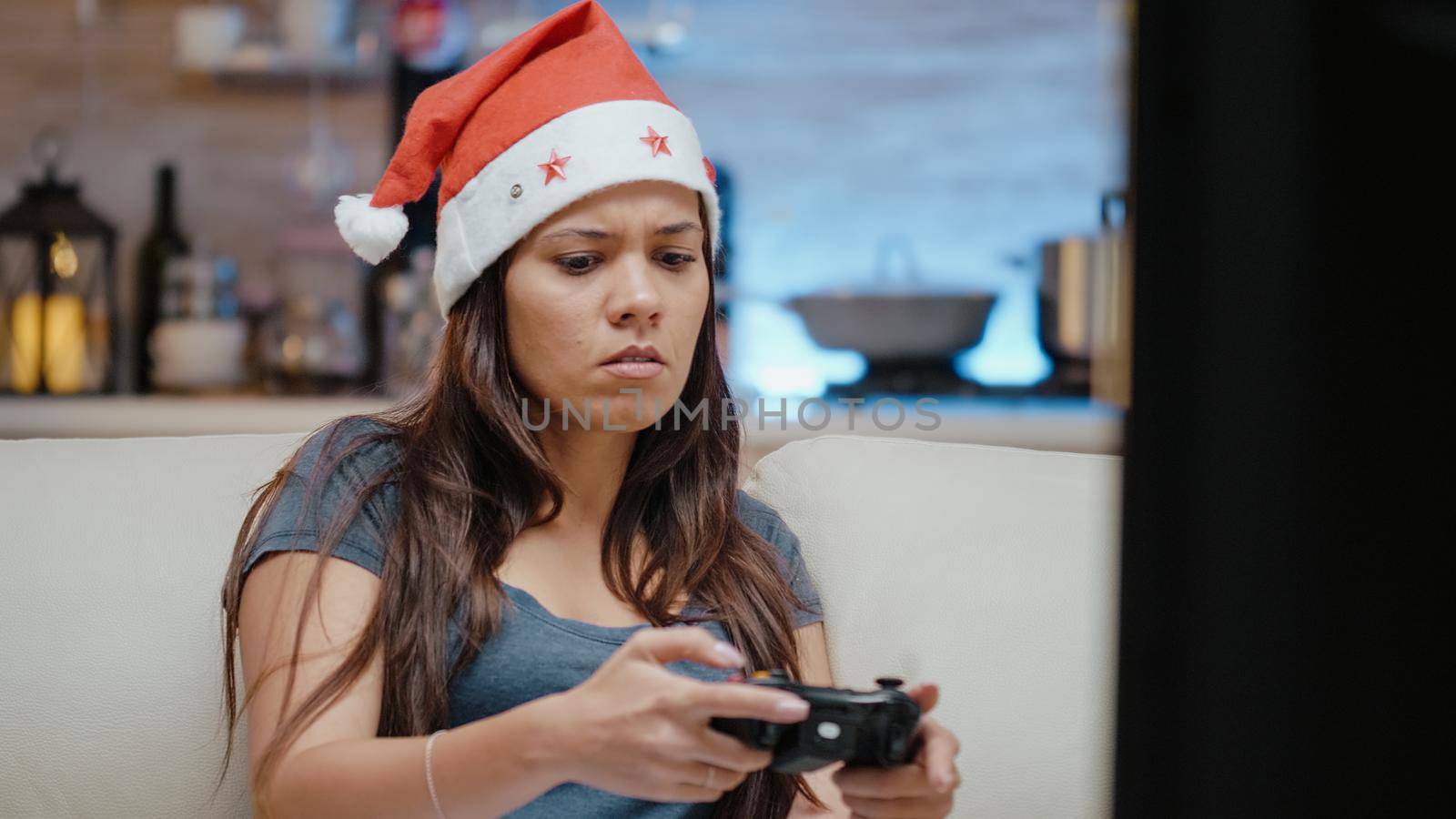 Close up of woman losing at video games on tv console with controller. Irritated person playing games with joystick on christmas eve to celebrate winter holiday with technology.