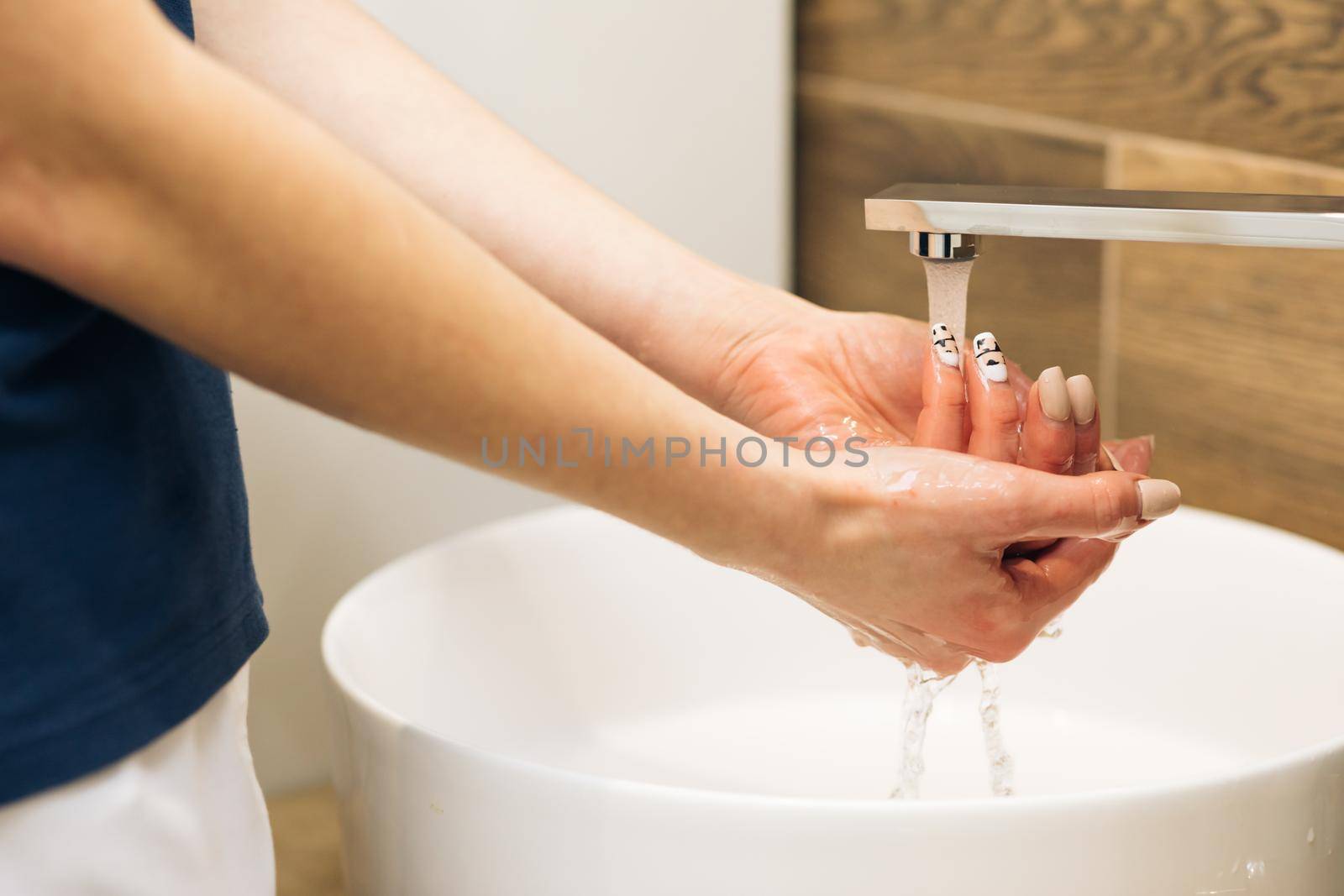 Wash hands with soap warm water rubbing fingers washing frequently or using hand sanitizer gel. Coronavirus pandemic prevention. Hands of woman wash their hands in a sink to wash the skin the hands.