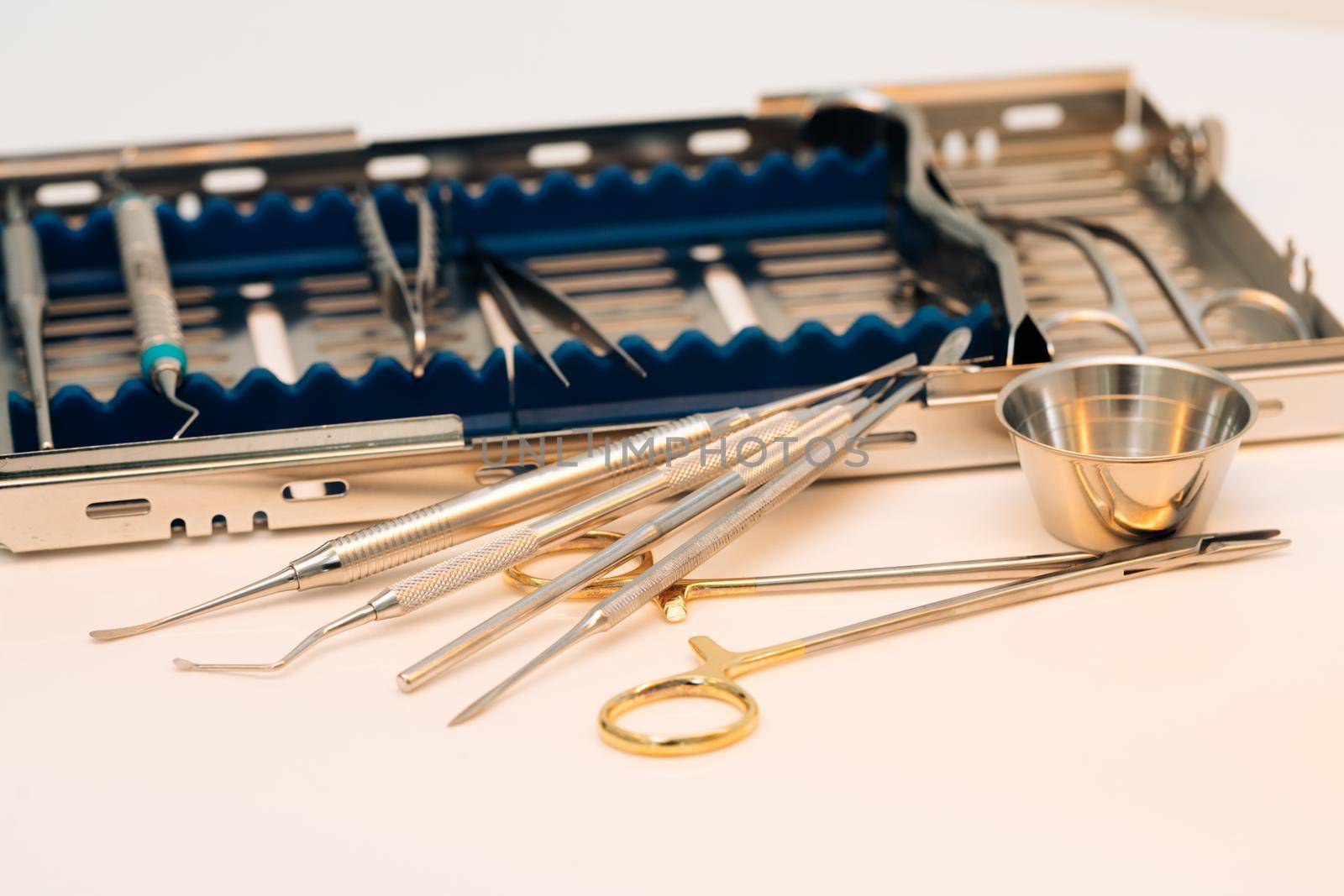 Surgical kit of instruments used in dental implantology. Dentist orthopedist tools. Dental implantation surgical set.