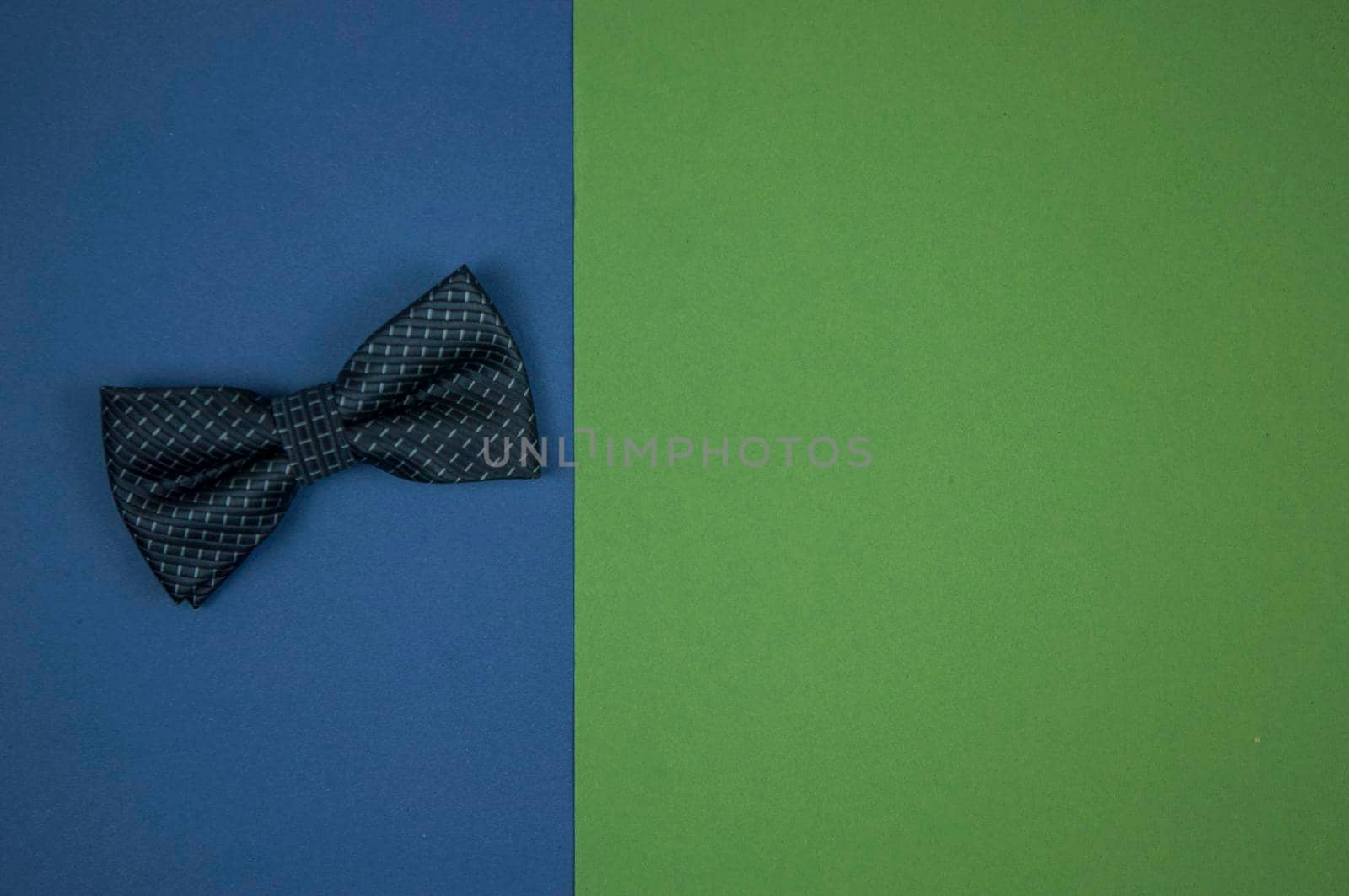 bow tie lies on a green-blue background. A place to copy. Top view. Close-up, copy space, background. Father day concept, card by inxti