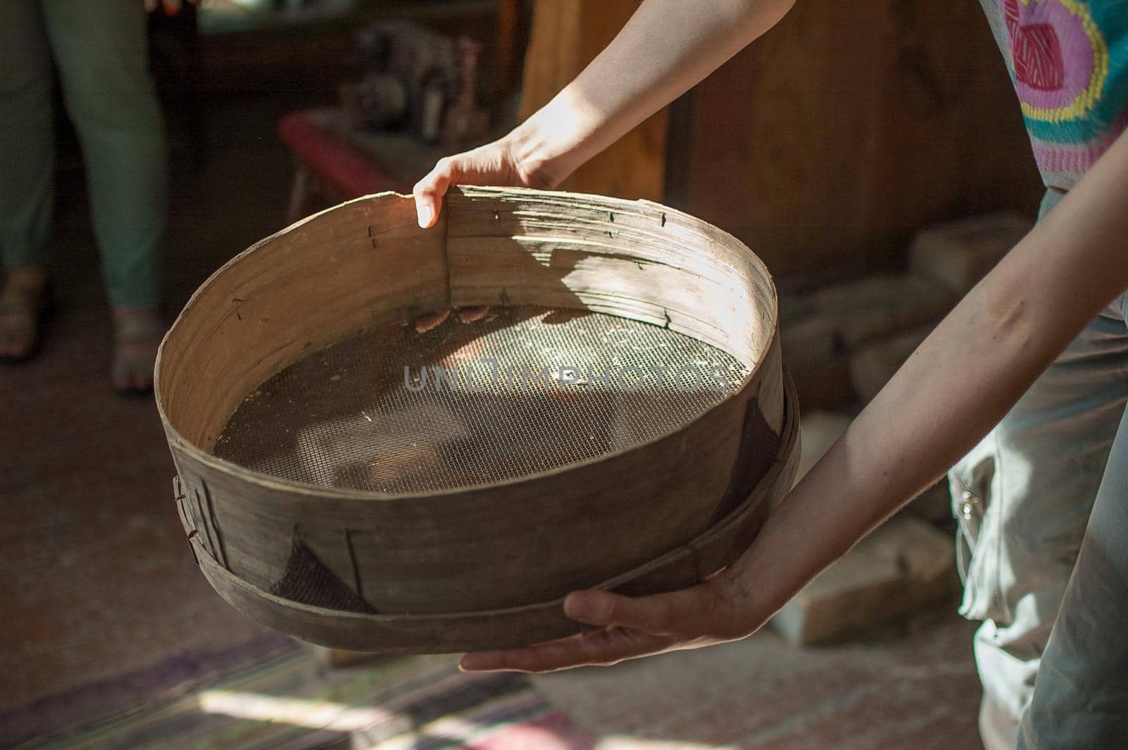 Old sieves, tool for bakery from the past for flour sifting in female hands by balinska_lv