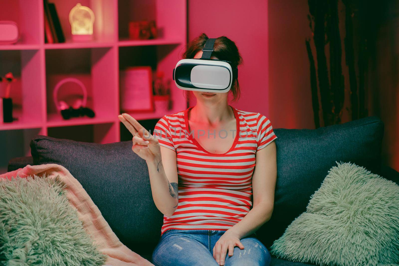 Young woman wear VR headset and touch virtual screen at night