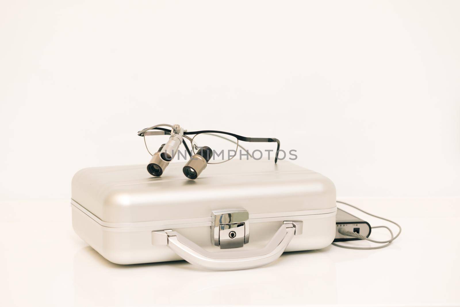 Dental and teethcare care tools. Orthodontist binocular. Spectacles magnifying binocular for dental surgery. Binoculars dentistry on the table.