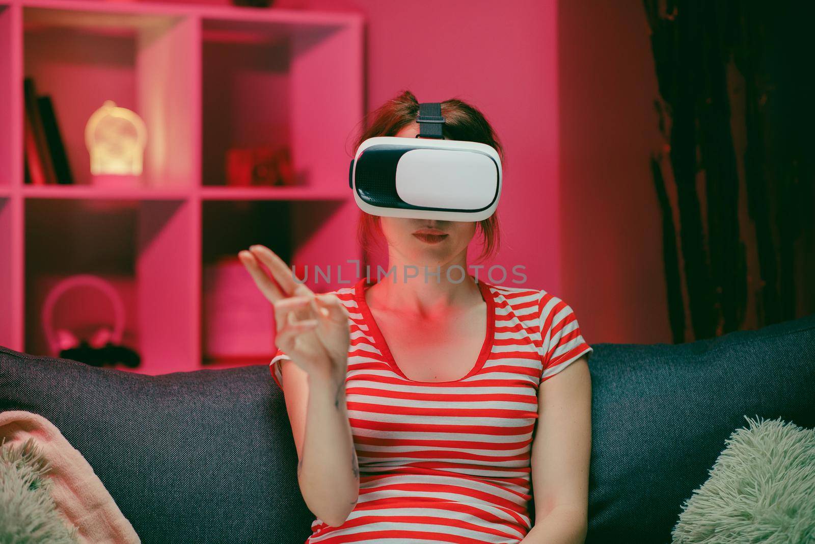 Young woman wear VR headset and touch virtual screen at night