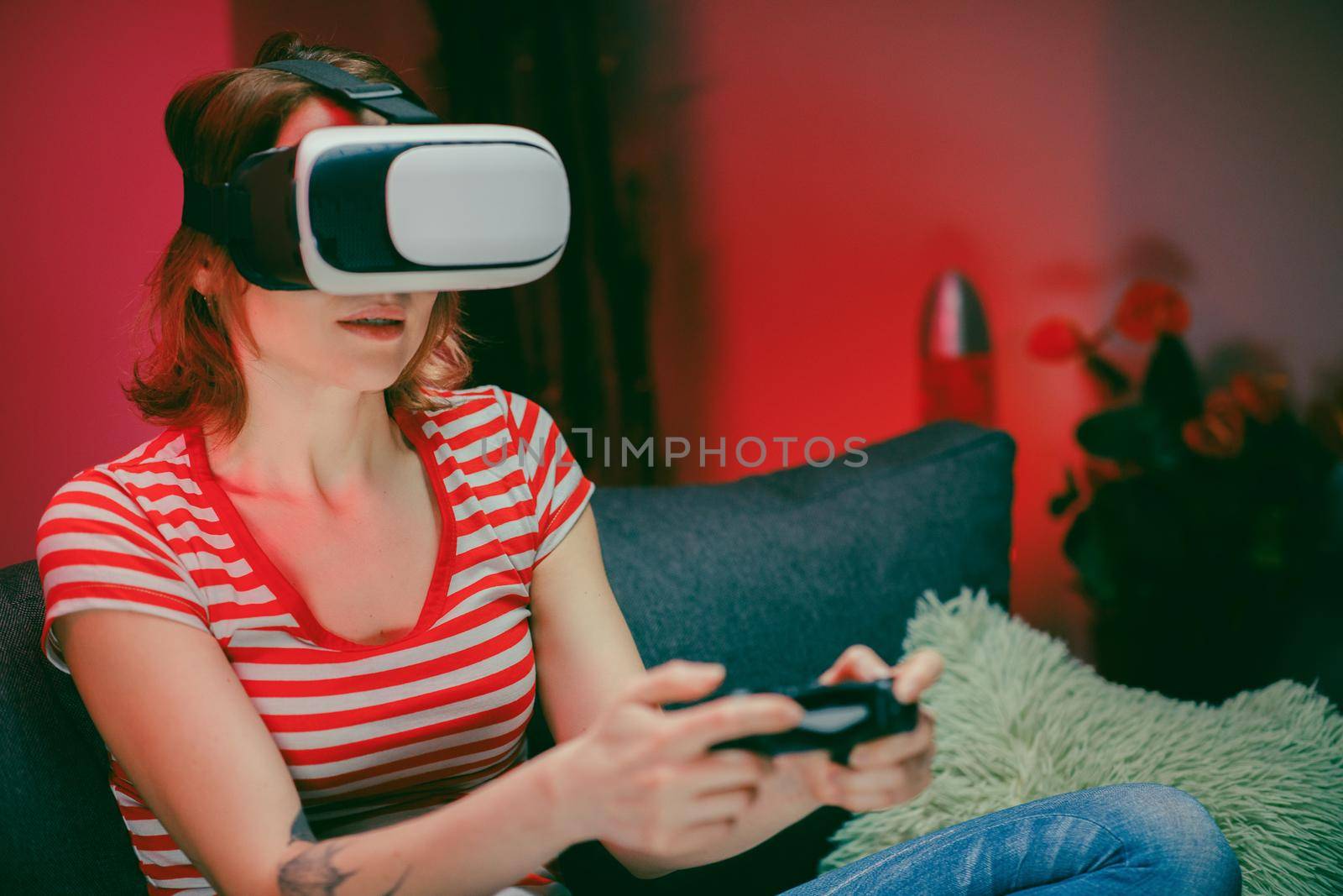 Emotional woman wear VR headset playing video game. Woman relaxing playing video games using vr headset. Caucasian female gamer.