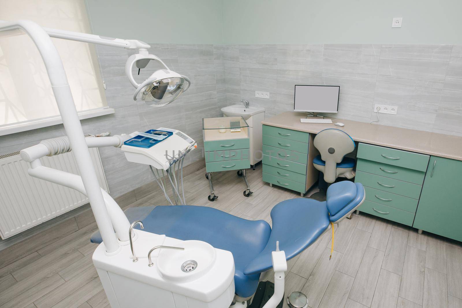 Dentist Office, Dental Hygiene, Dentist's Chair. Modern dental practice. Dental chair and other accessories used by dentists in blue, medic light