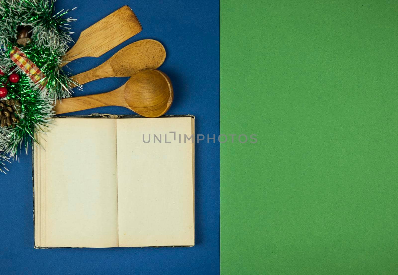 wood spoons is lying on green and blue background with christmas decorated. Christmas menu. Copy space. by inxti