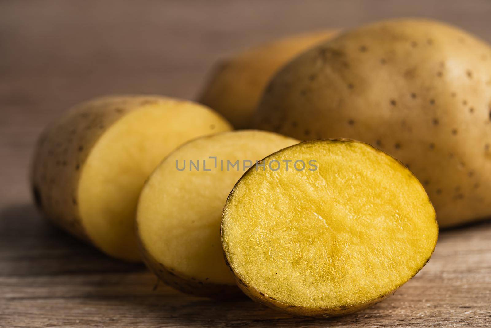 Potato raw and fresh vegetable food on wooden background.