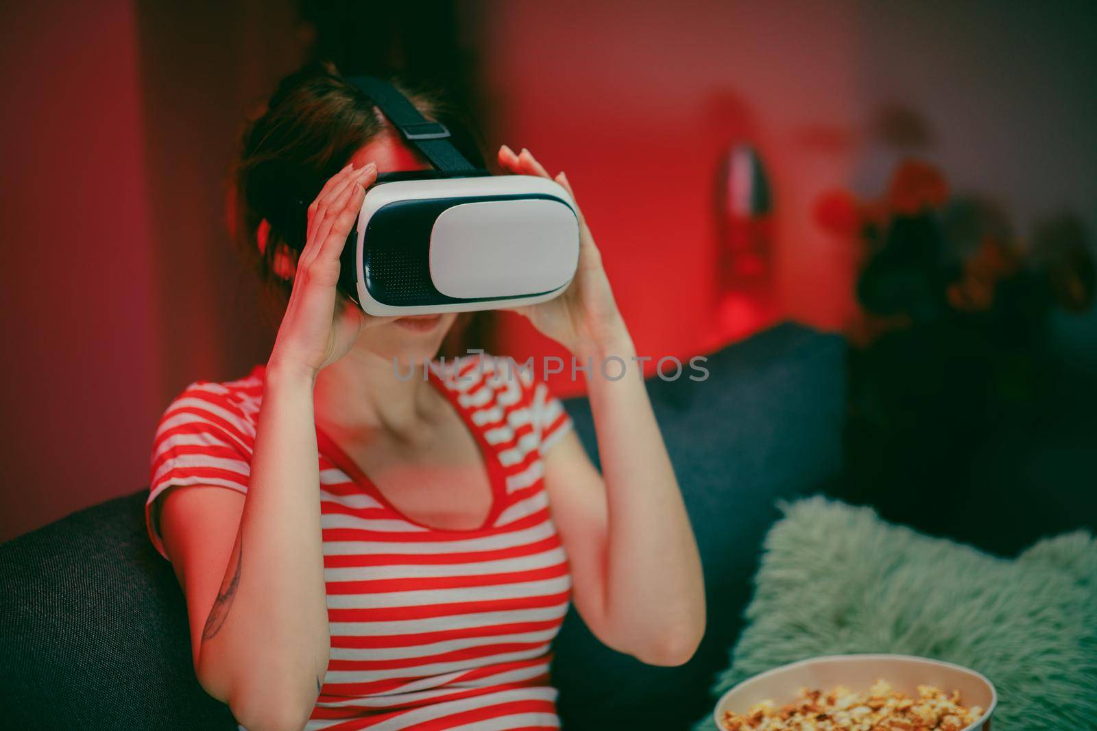 Woman wear VR headset playing video game. Woman relaxing playing video games using vr headset. Caucasian female gamer
