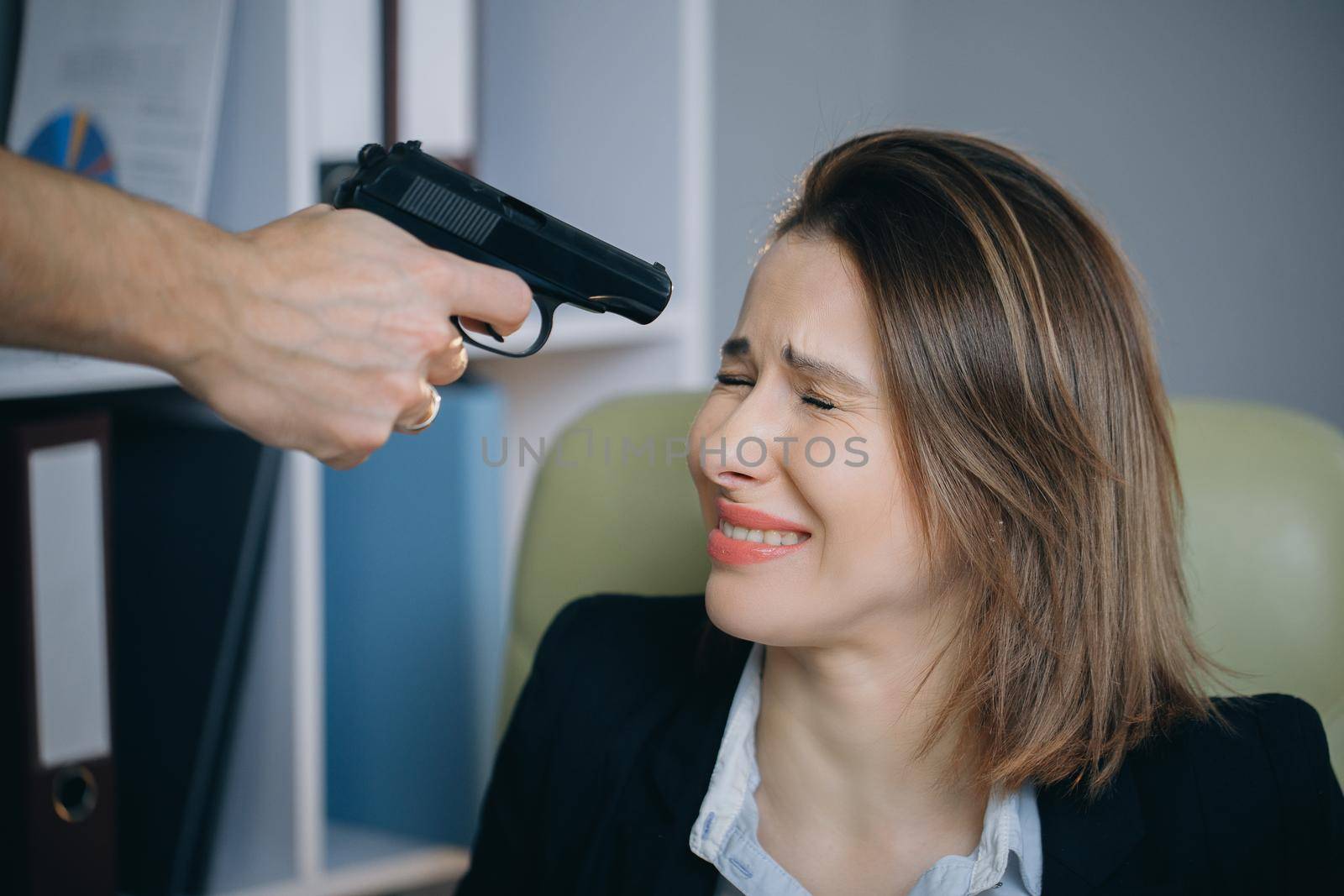 Serial killer holding a gun in his hand. Depression, failure, suicide.