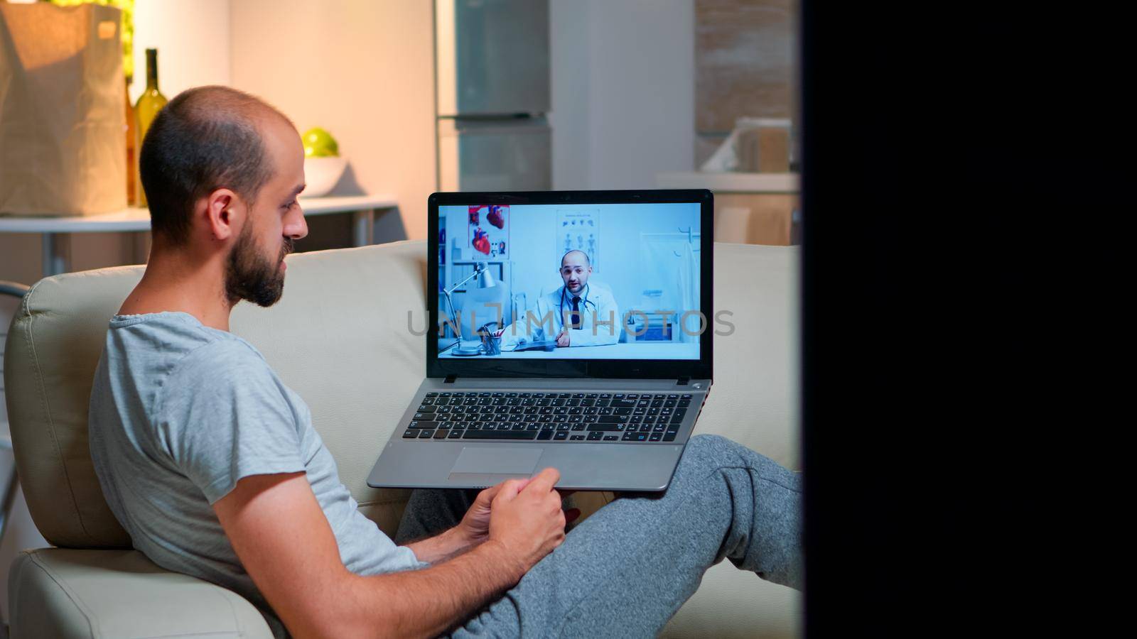 Sick man having online telemedicine consultation during covid-19 by DCStudio