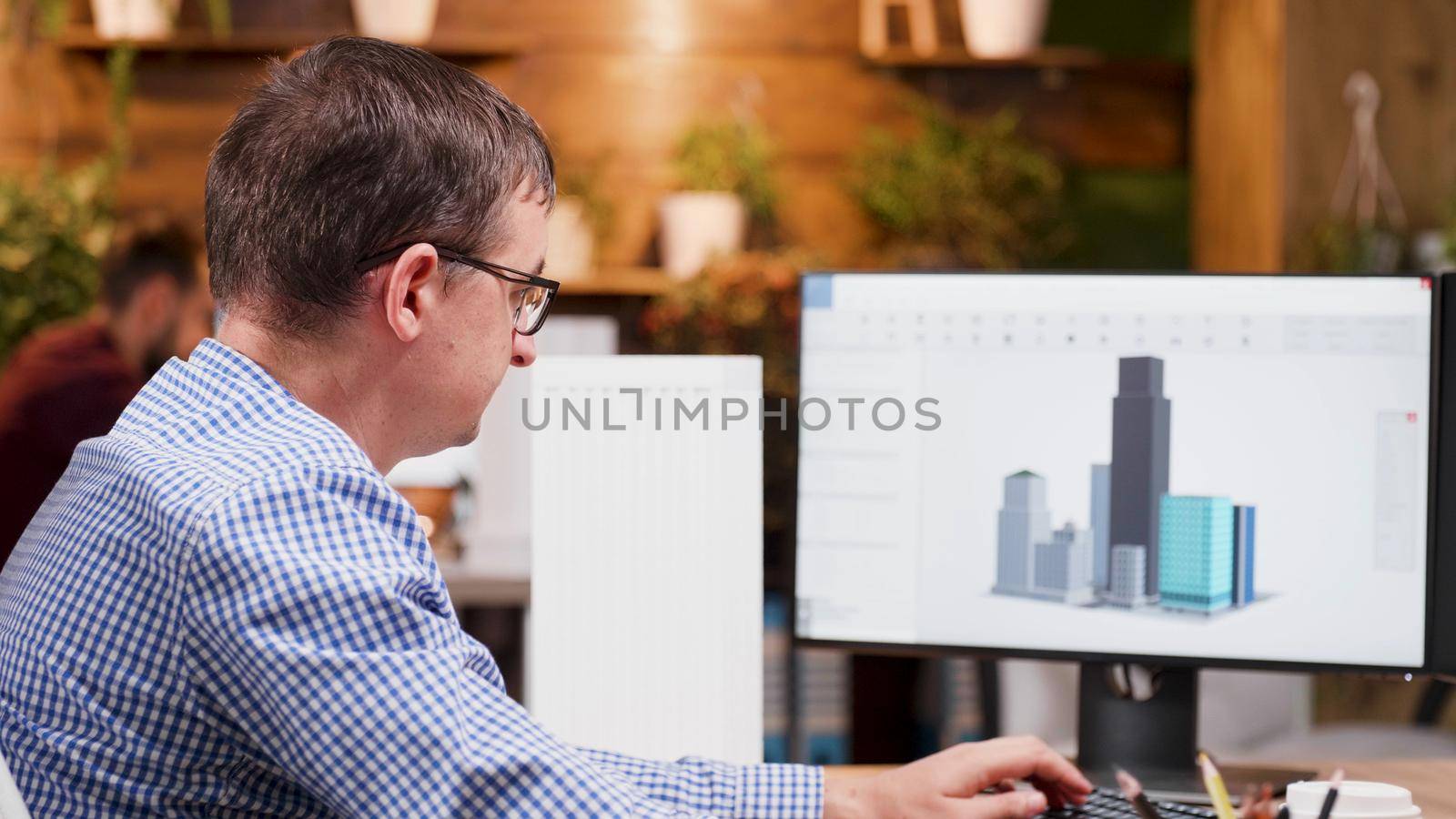 Engineer man working at architectural building prototype on computer using digital company software. Workaholic architect developing industrial construction structure for creativity project