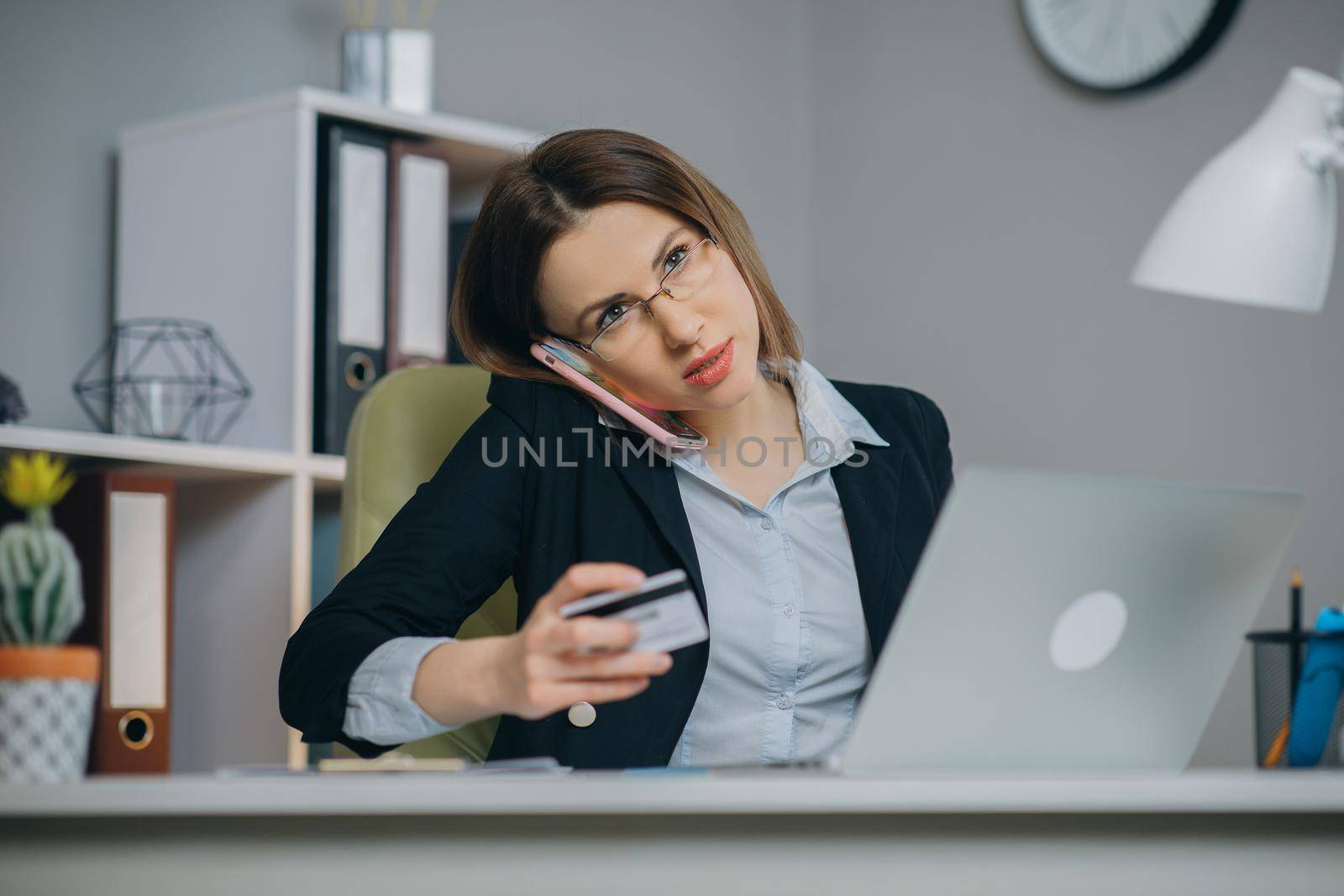 Woman using credit card for shopping online and entering security code using on laptop keyboard. E-commerce and Online shopping concept. by uflypro