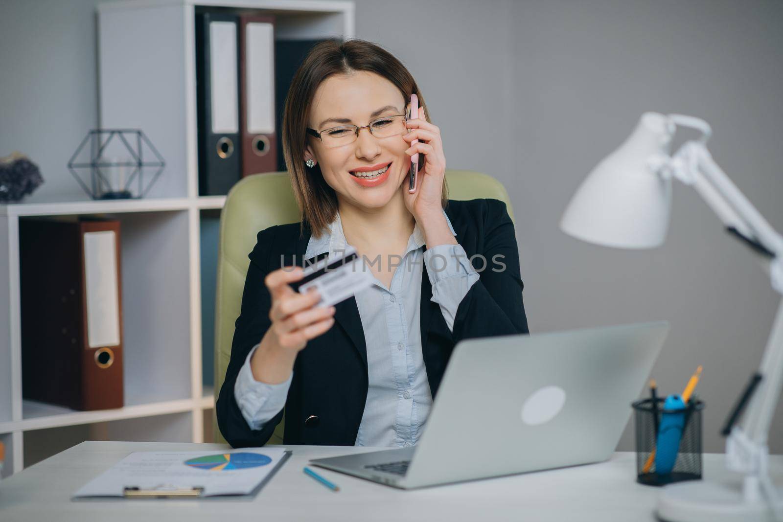 Woman making online purchase. Online payment service. Close up of woman hands hold credit card and using laptop for online shopping