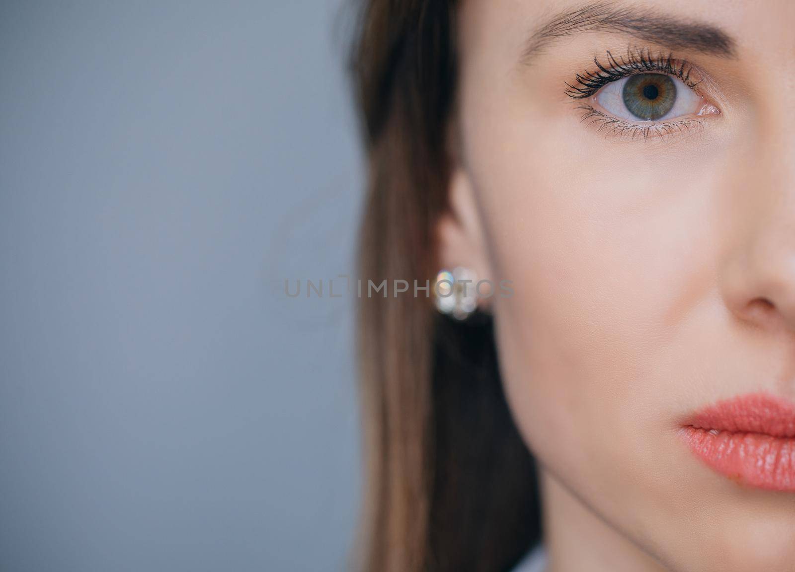 Close up of female face isolated on background with copy space. Beautiful Young European Girl.