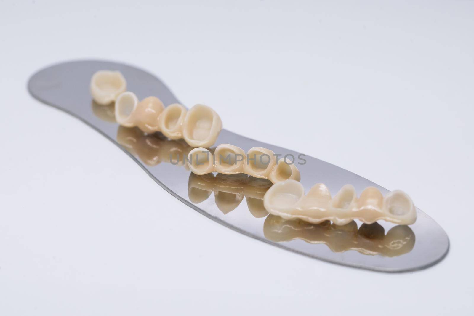 Metal free ceramic dental crowns. Zirconium tooth crown Isolate on wite background. Aesthetic restoration of tooth loss.