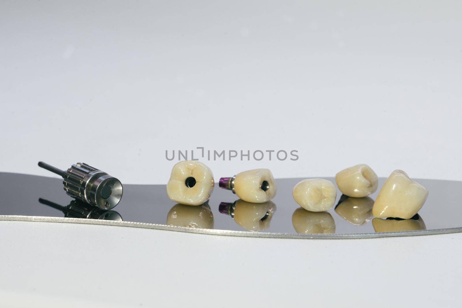 Zirconium crown and zirconium hybrid abutment. Monolithic screw retained zirconium crown on the implant, a screw and a manual key for screwing the crown by uflypro