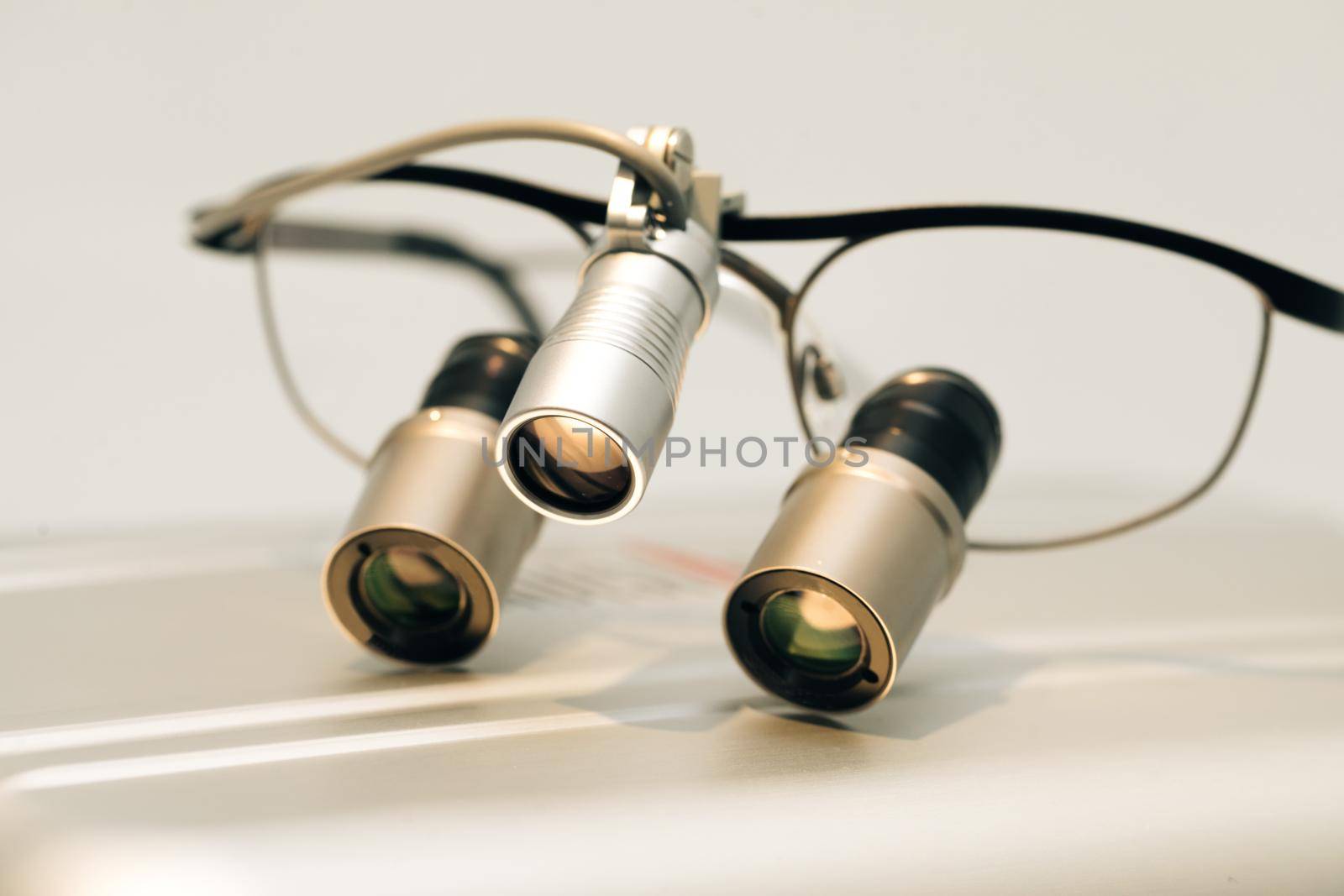 Spectacles magnifying binocular for dental surgery. Binoculars dentistry on the table. Orthodontist binocular. Dental and teethcare care tools.