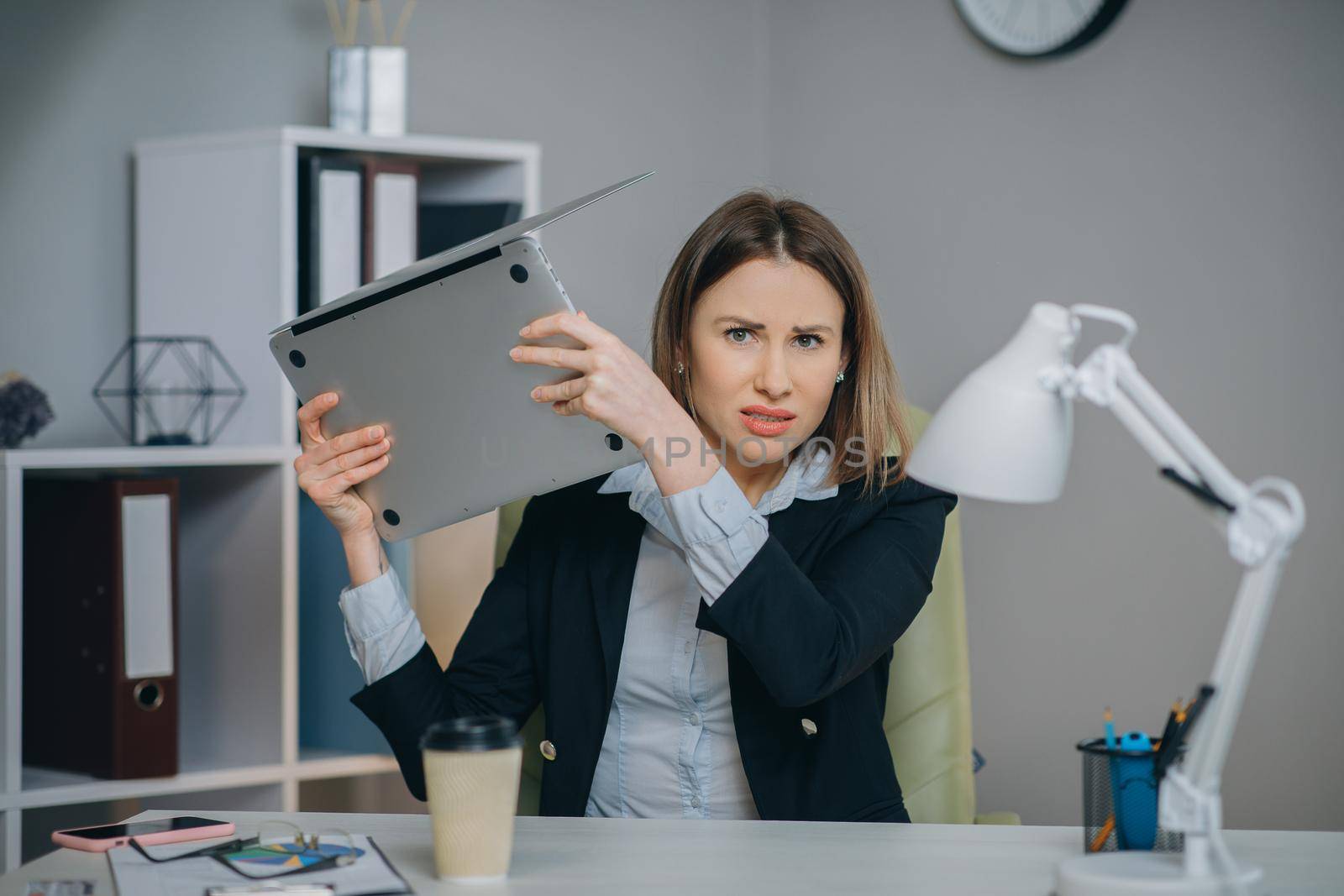 Stressed businesswoman annoyed using stuck laptop, angry woman mad about computer problem frustrated with data loss, online mistake, software error or system failure. by uflypro