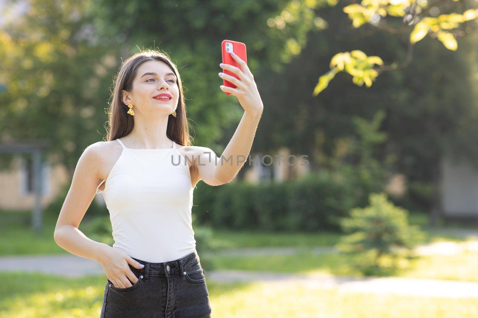 Portrait of a happy young female taking selfie. Girl communicating with friend online make video call talking record lifestyle vlog distance job interview.