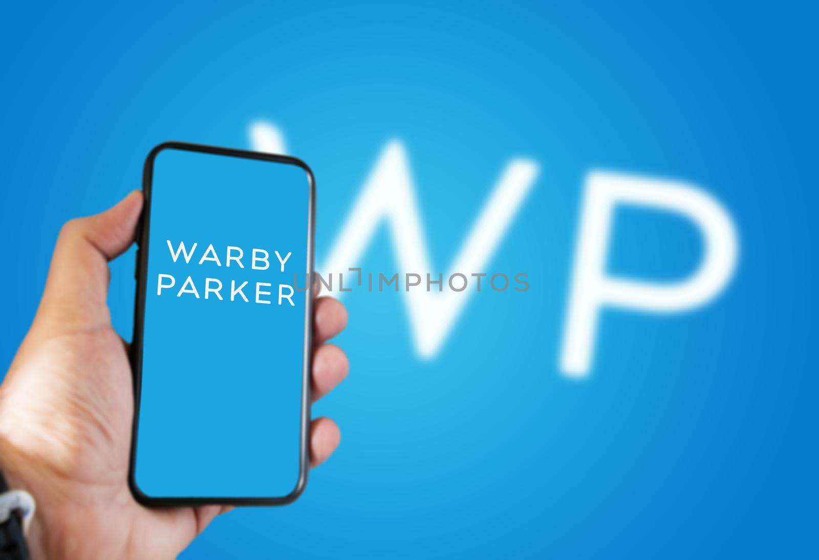 New York, USA, September 2021: hand holding a phone with the Warby Parker mobile app on the screen by rarrarorro