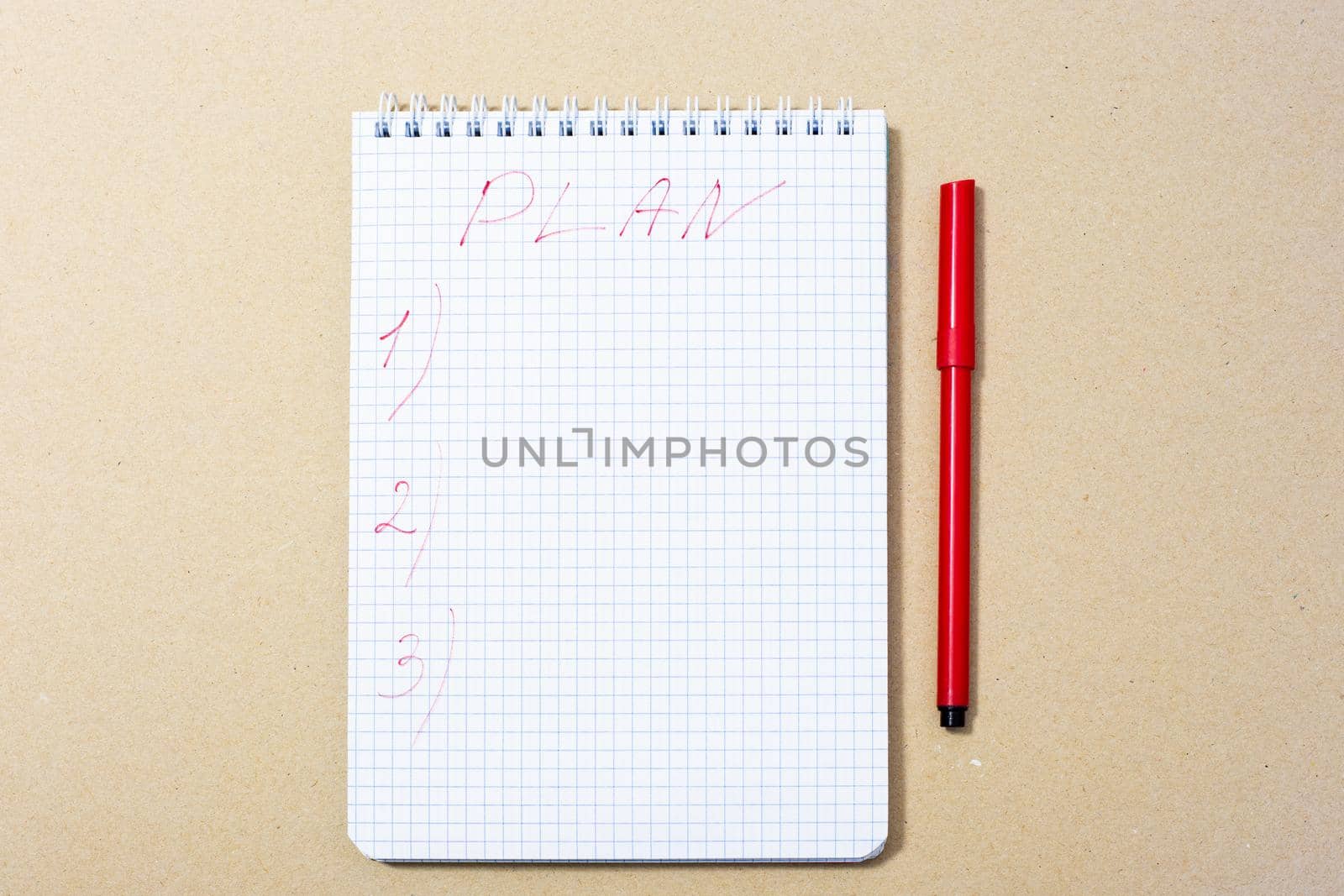notepad and red marker near, top view