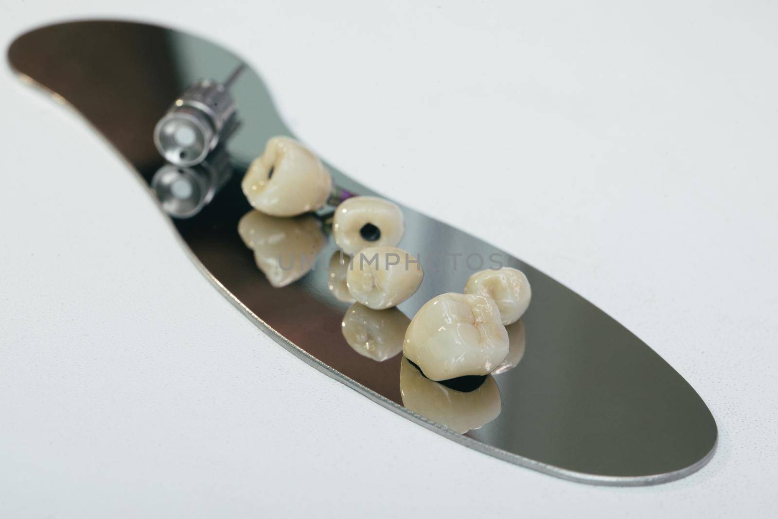 Zirconium dental crown artificial chewing tooth with orthopedic screwdriver. zirconium crown and zirconium hybrid abutment