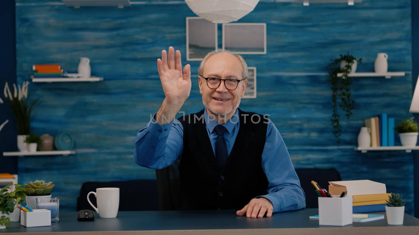 POV of elderly aged man waving during a video conference by DCStudio