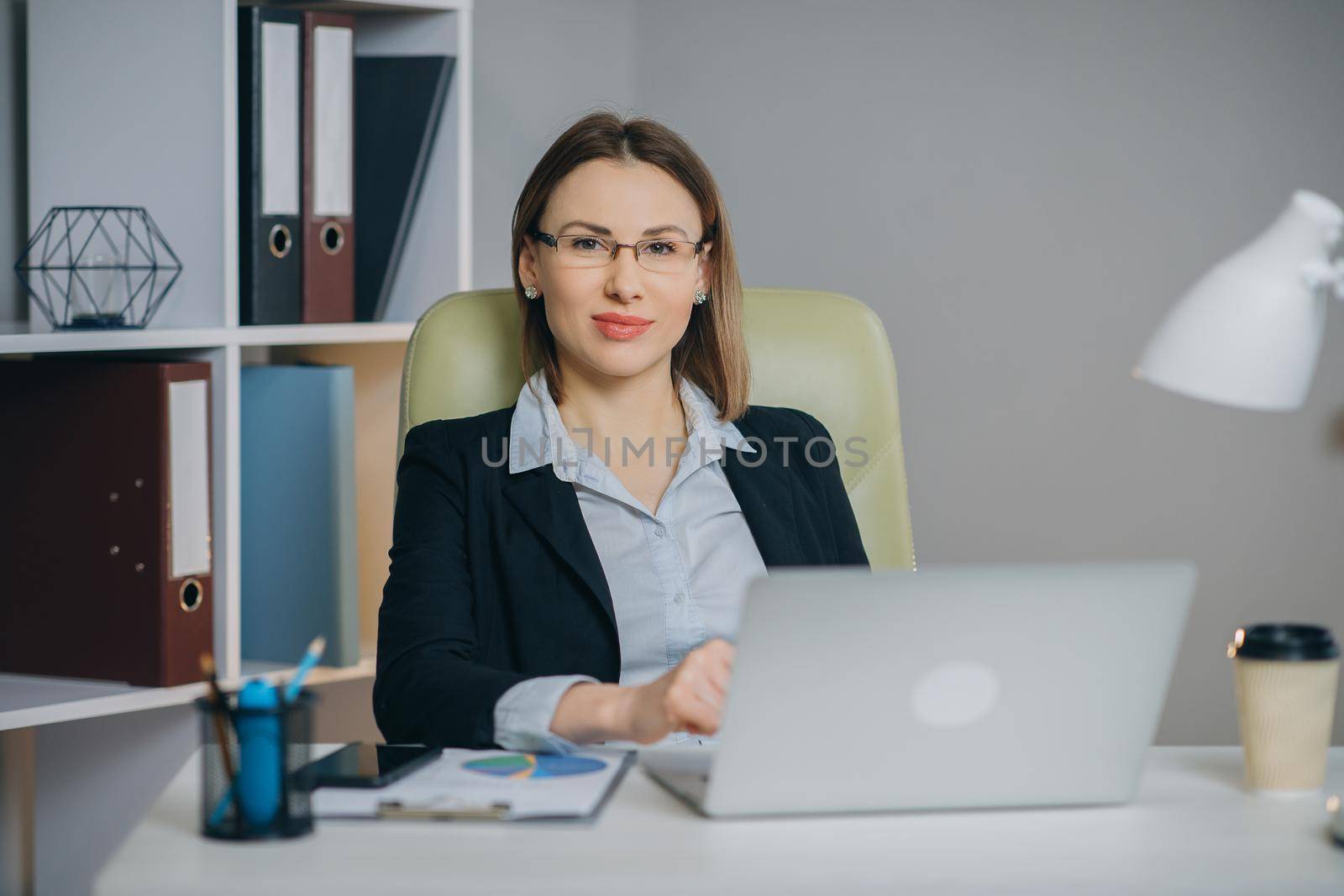 Woman professional using laptop sit at office desk, happy female customer make confirming online website