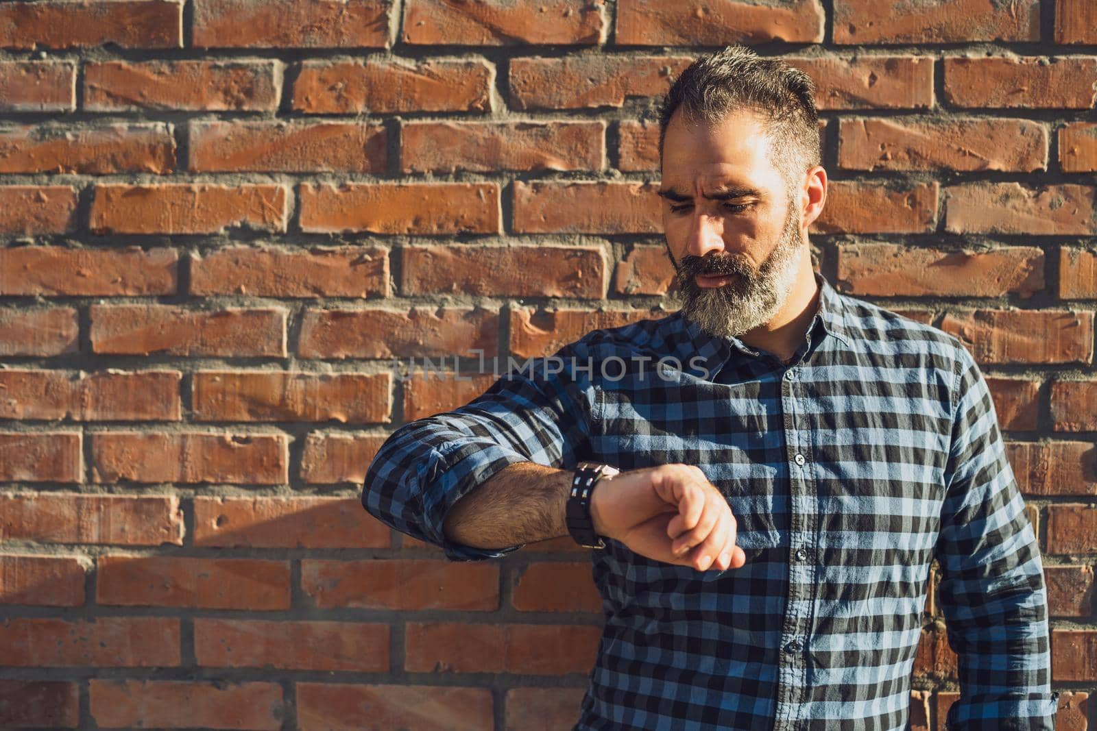 Businessman  looking at his watch by Bazdar