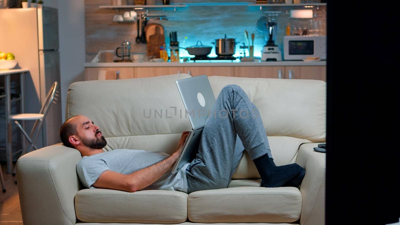 Exhausted man falling asleep while working on internet communication project by DCStudio