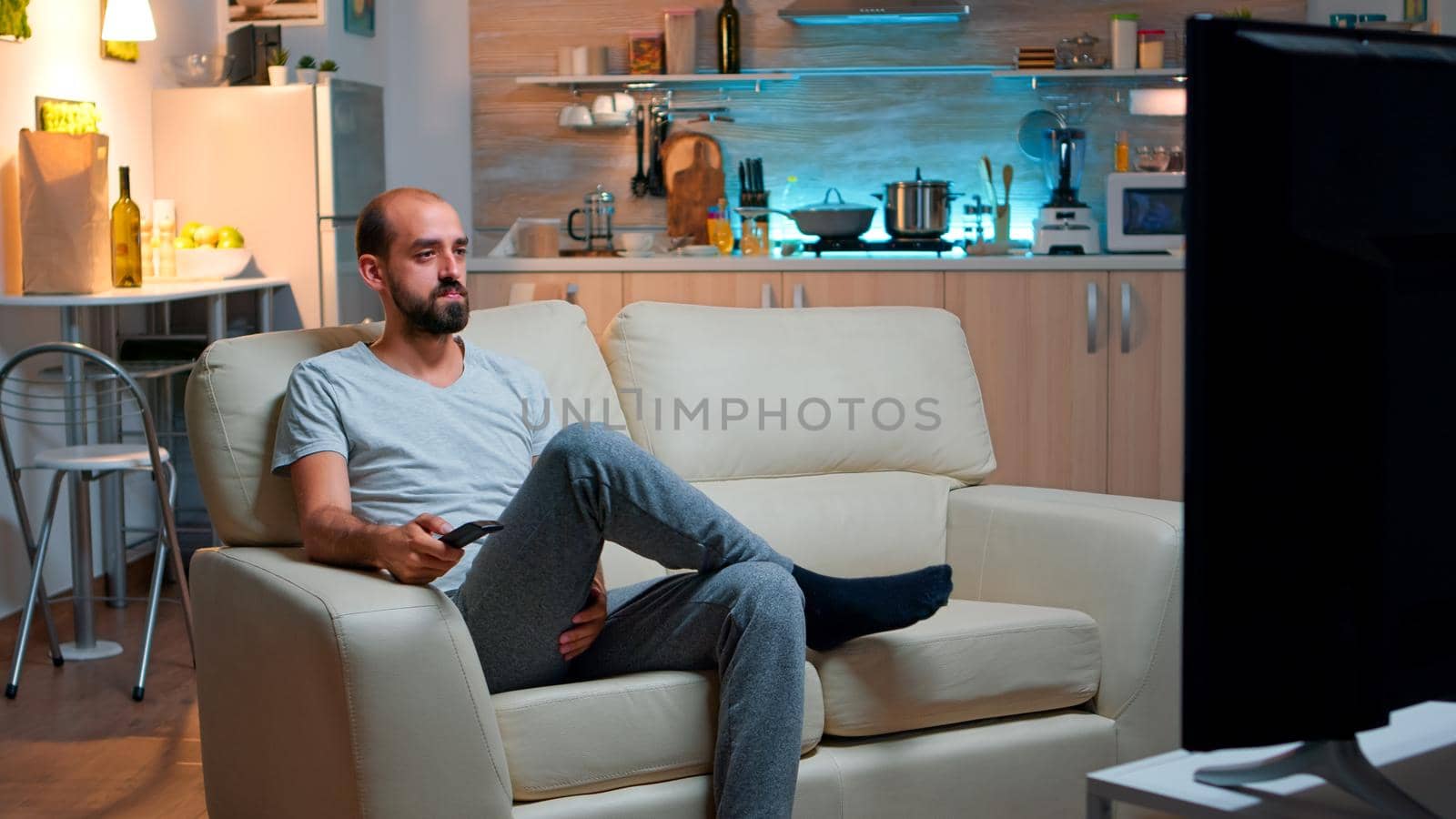 Concentrated man with beard watching movie show by DCStudio
