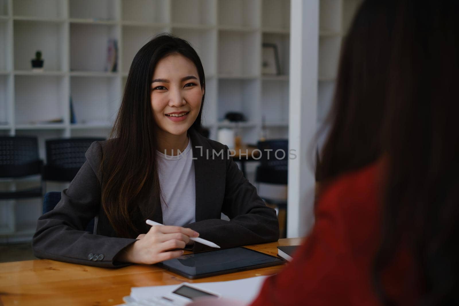 During a job interview, Woman in a suit and gives a presentation about herself.