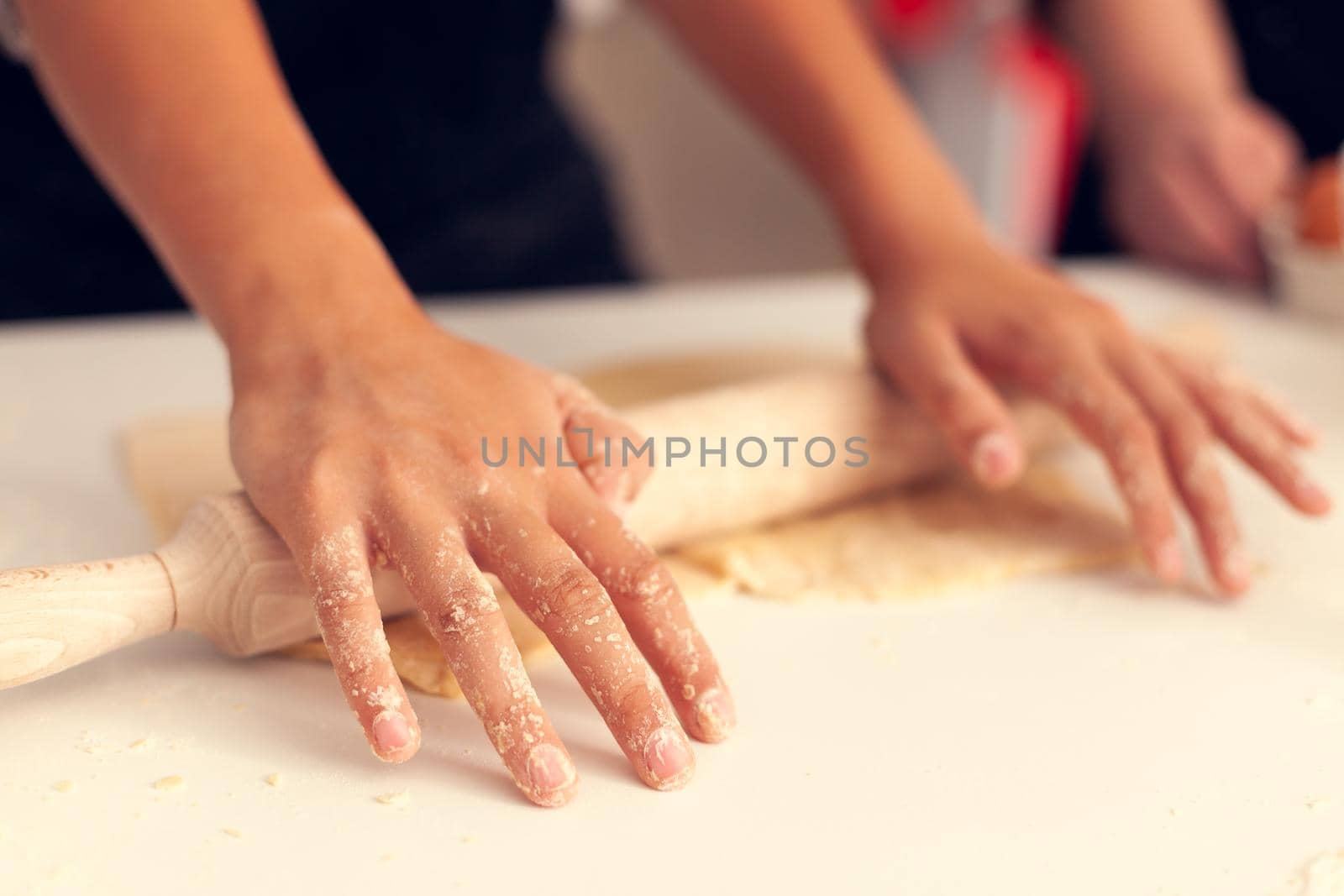 Granddaughter knead dough on christmas day. Happy cheerful joyfull teenage girl helping senior woman preparing sweet cookies to celebrate winter holidays.