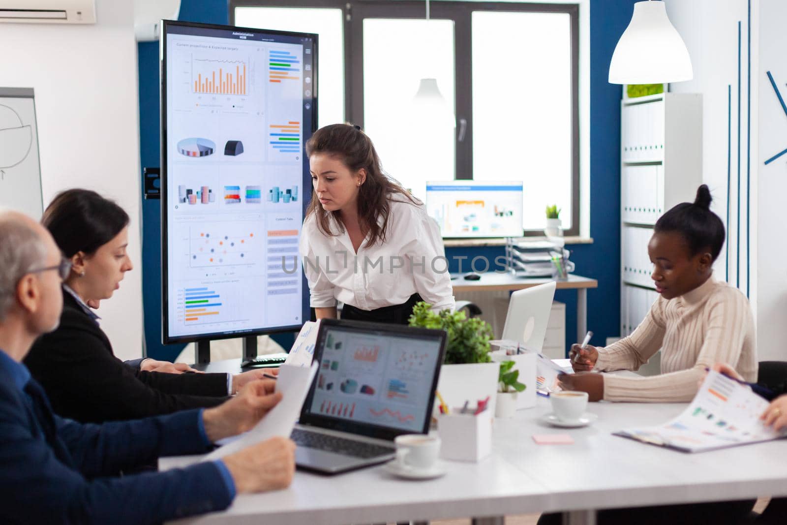 Furious woman screaming at company office boardroom meeting having disagreement controversy. Businesswoman raging about multitasking difficult job, screaming in boardroom