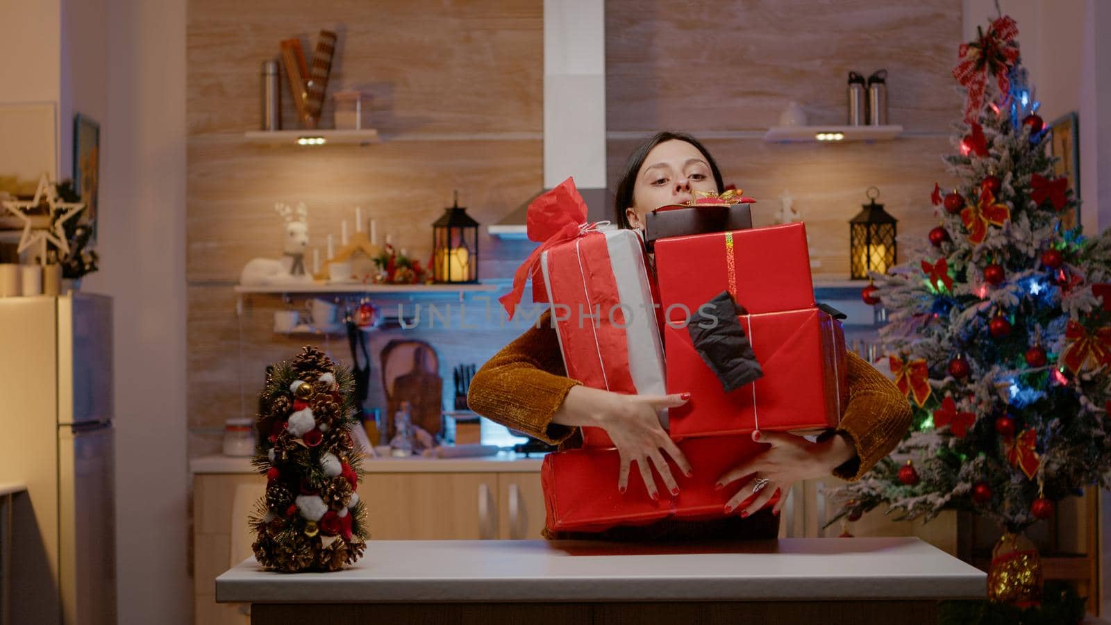 Festive woman feeling frustrated about christmas festivity, dropping gift boxes on floor, preparing presents for holiday celebration. Couple with gifts for relatives sharing christmas spirit.