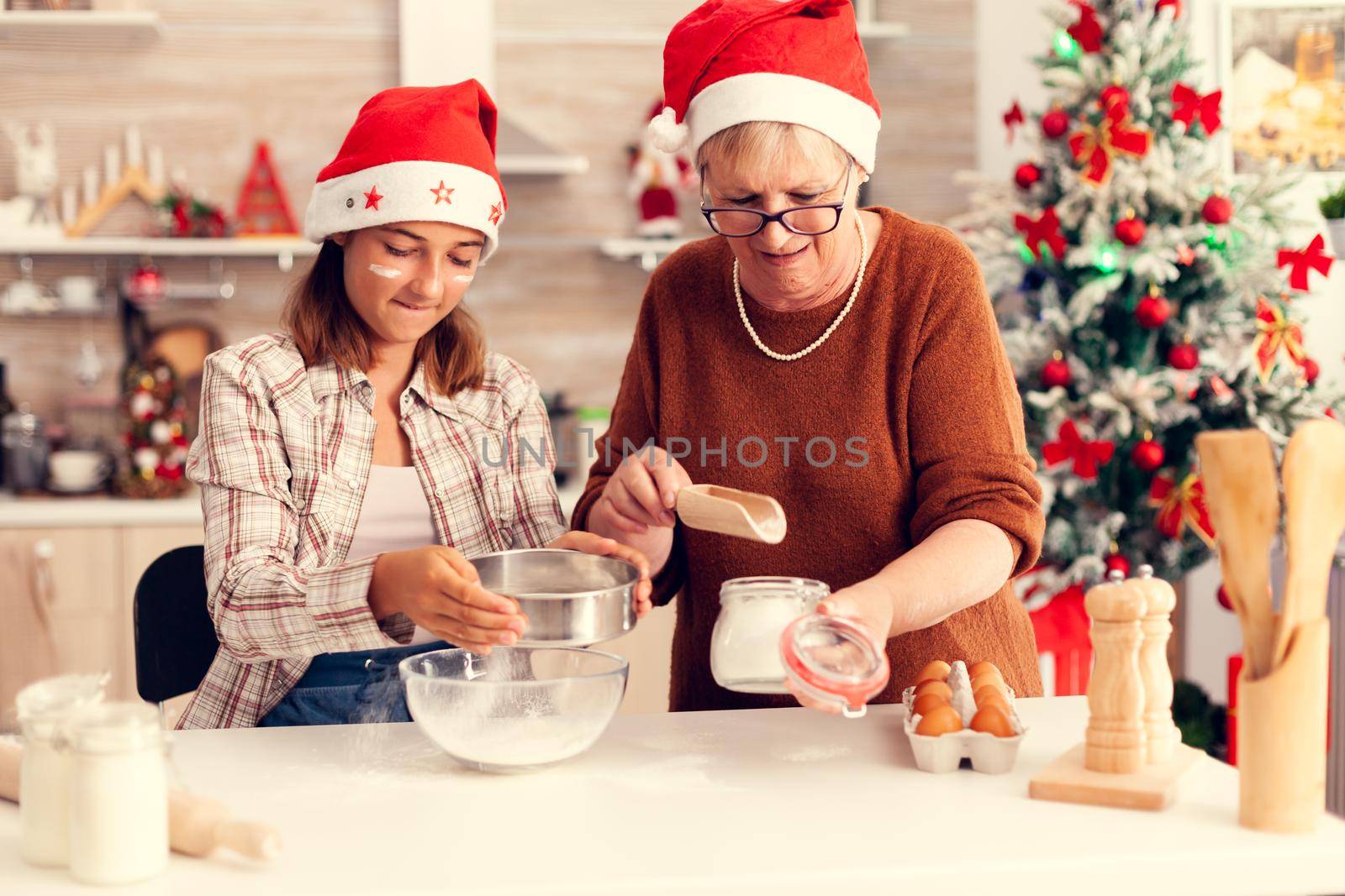 Joyful child in kitchen on christmas day with x-mas tree by DCStudio