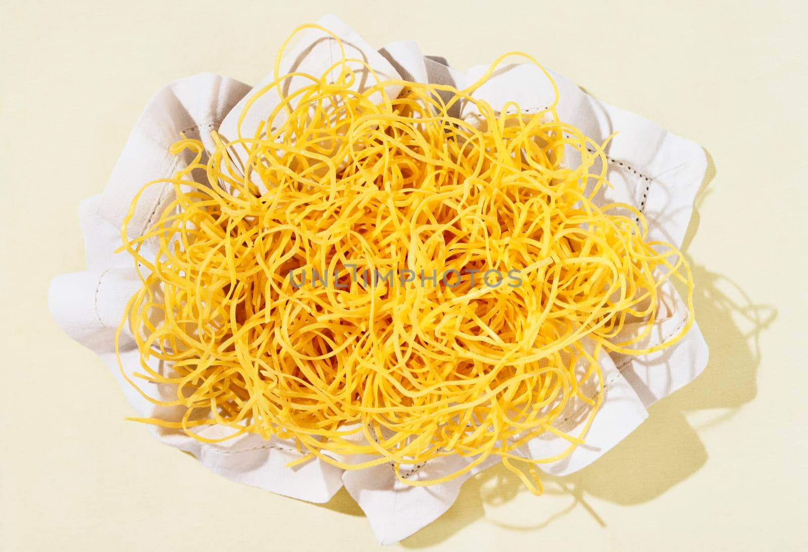  Fresh tagliatelle pasta in white napkin , beautiful long flat yellow ribbons of raw pasta