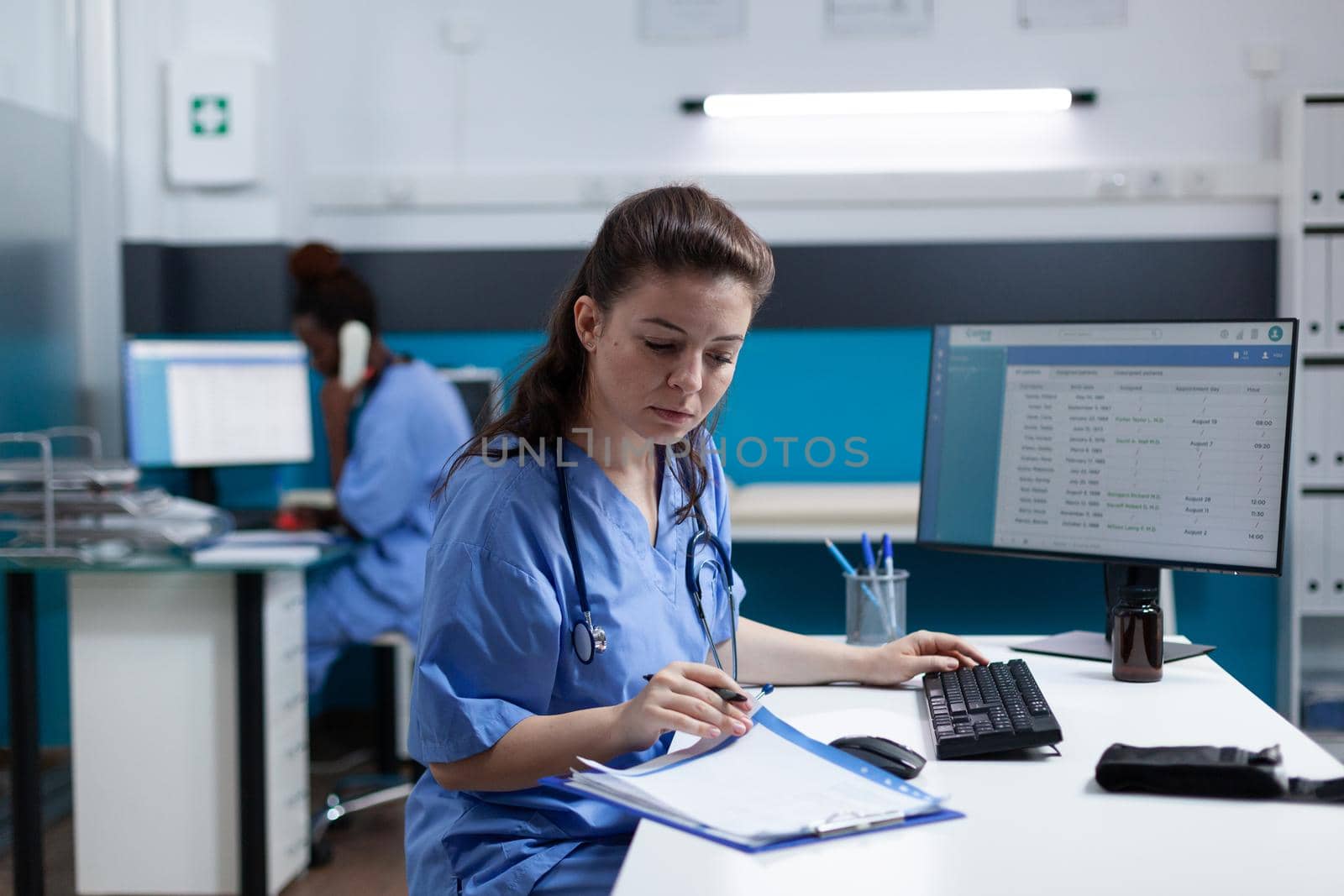 Pharmacist nurse with stethoscope analyzing healthcare treatment by DCStudio