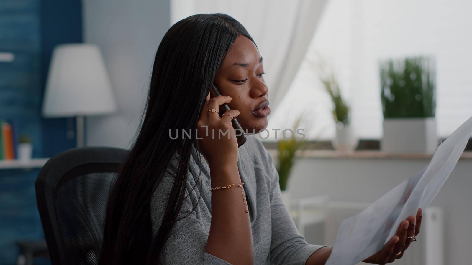 Upset black student sitting at desk explaining financial homework discussing with collegue by DCStudio