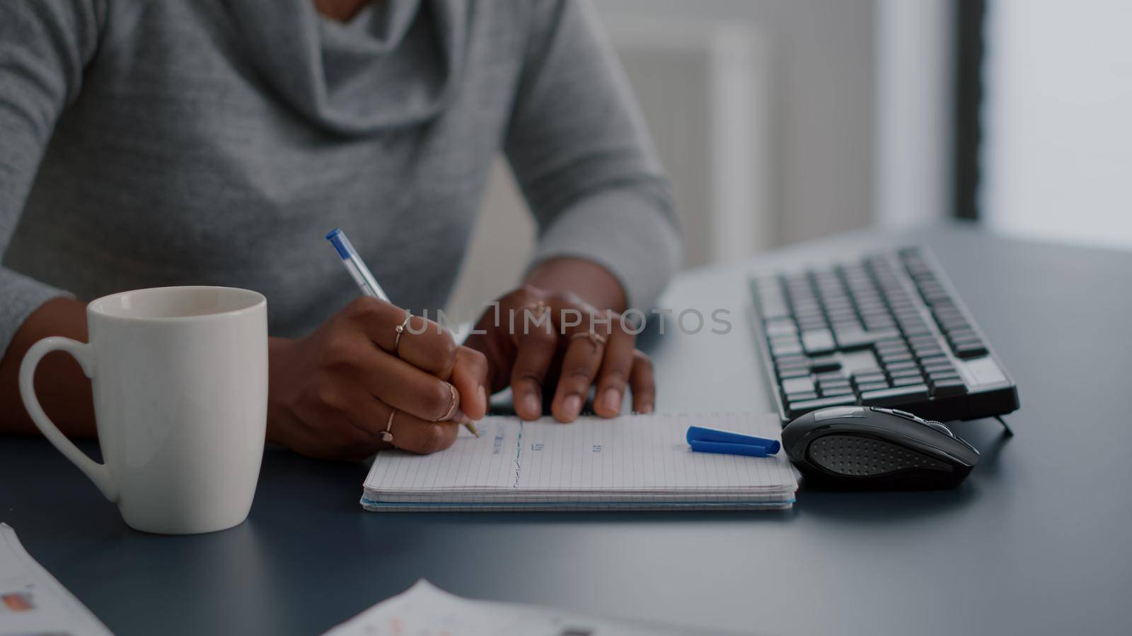 African american student writing high school homework on notebook working remote from home. Black woman studying math using elearning univeristy platform during online courses sitting at desk