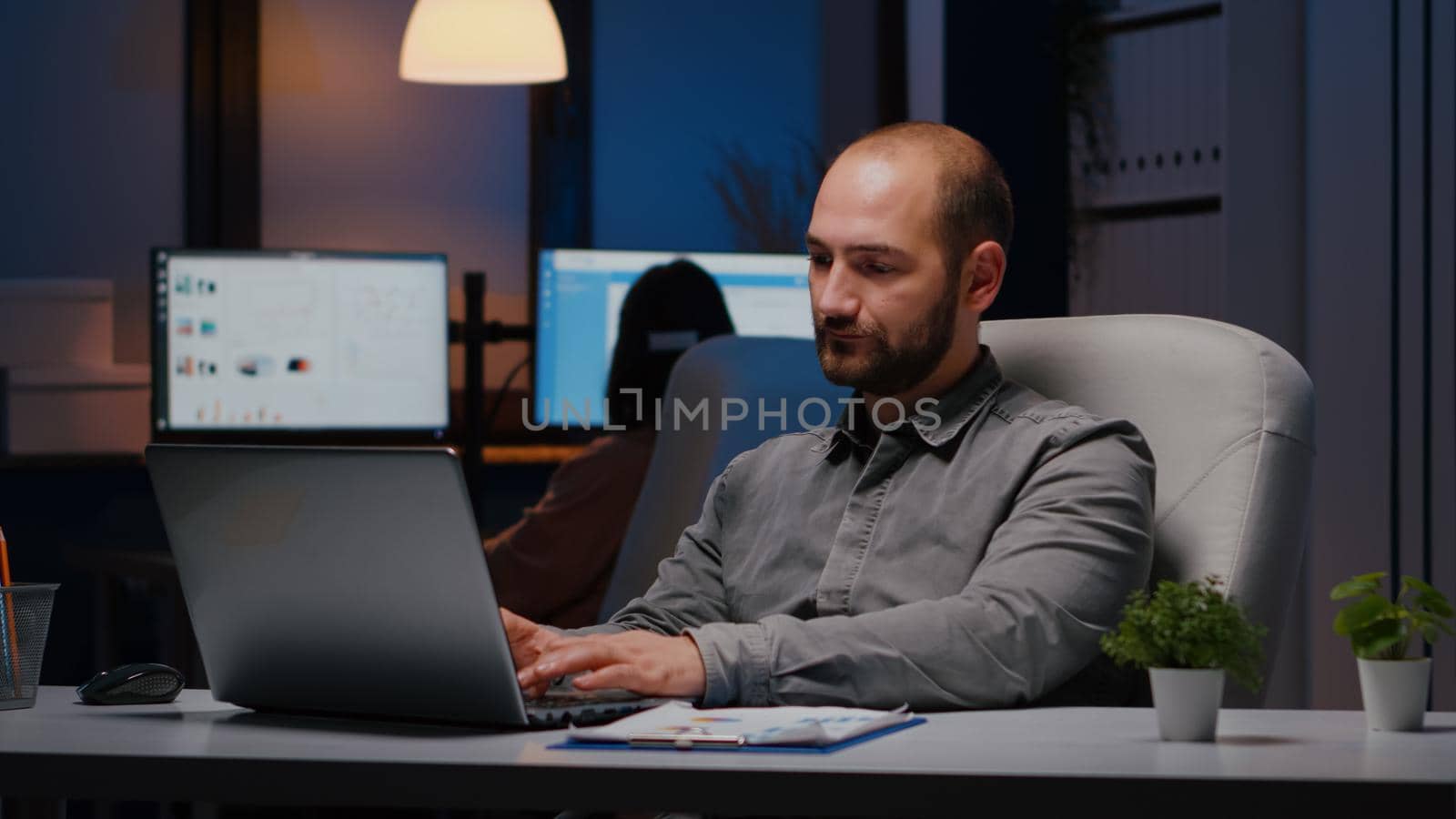 Portrait of businessman working on laptop computer planning financial strategy by DCStudio